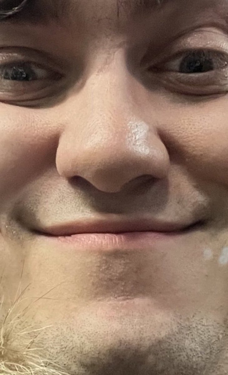 Ultra closeup of Ed Zitron smiling scarily 