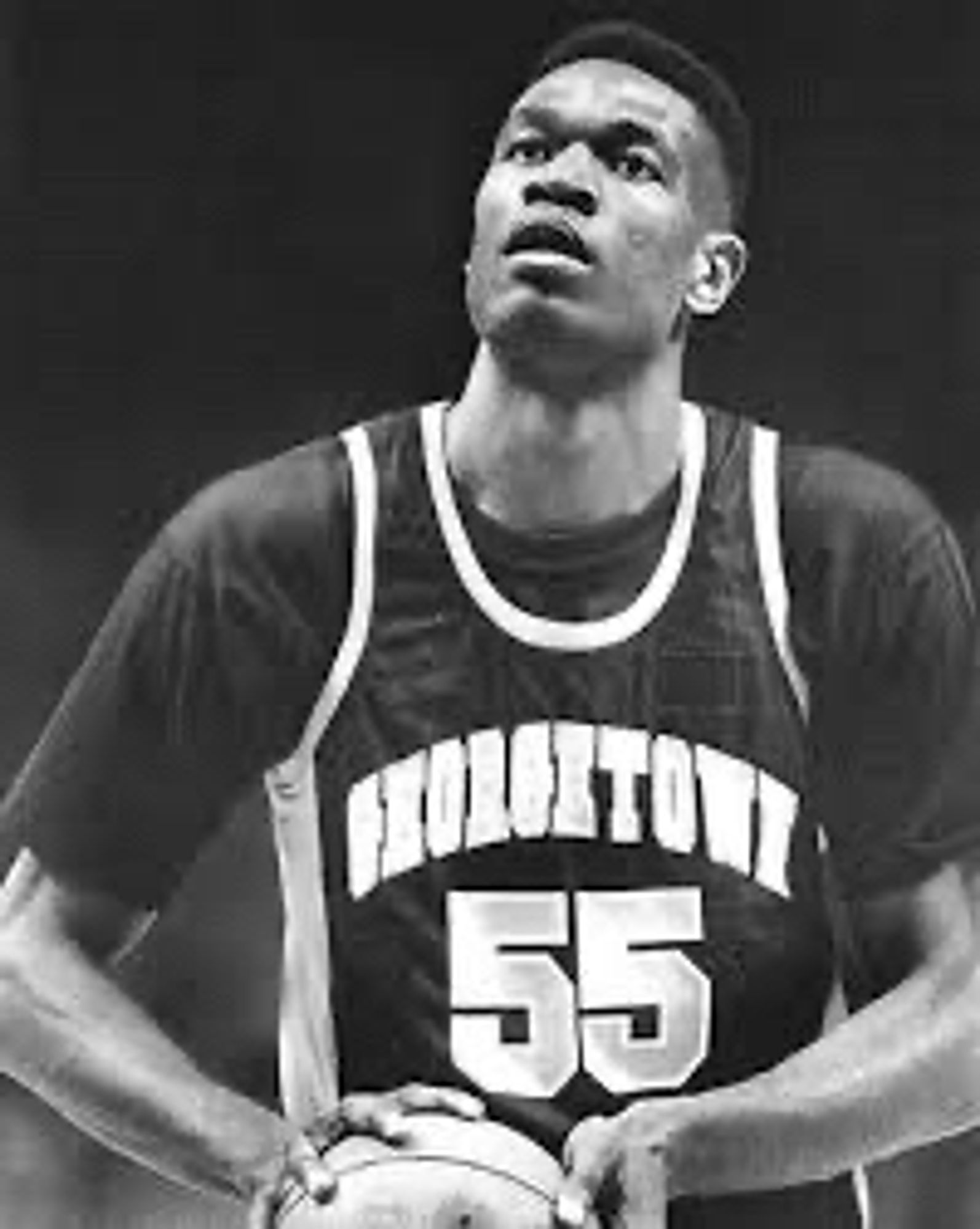 Dikembe Mutombo shooting a free throw in a Georgetown jersey.