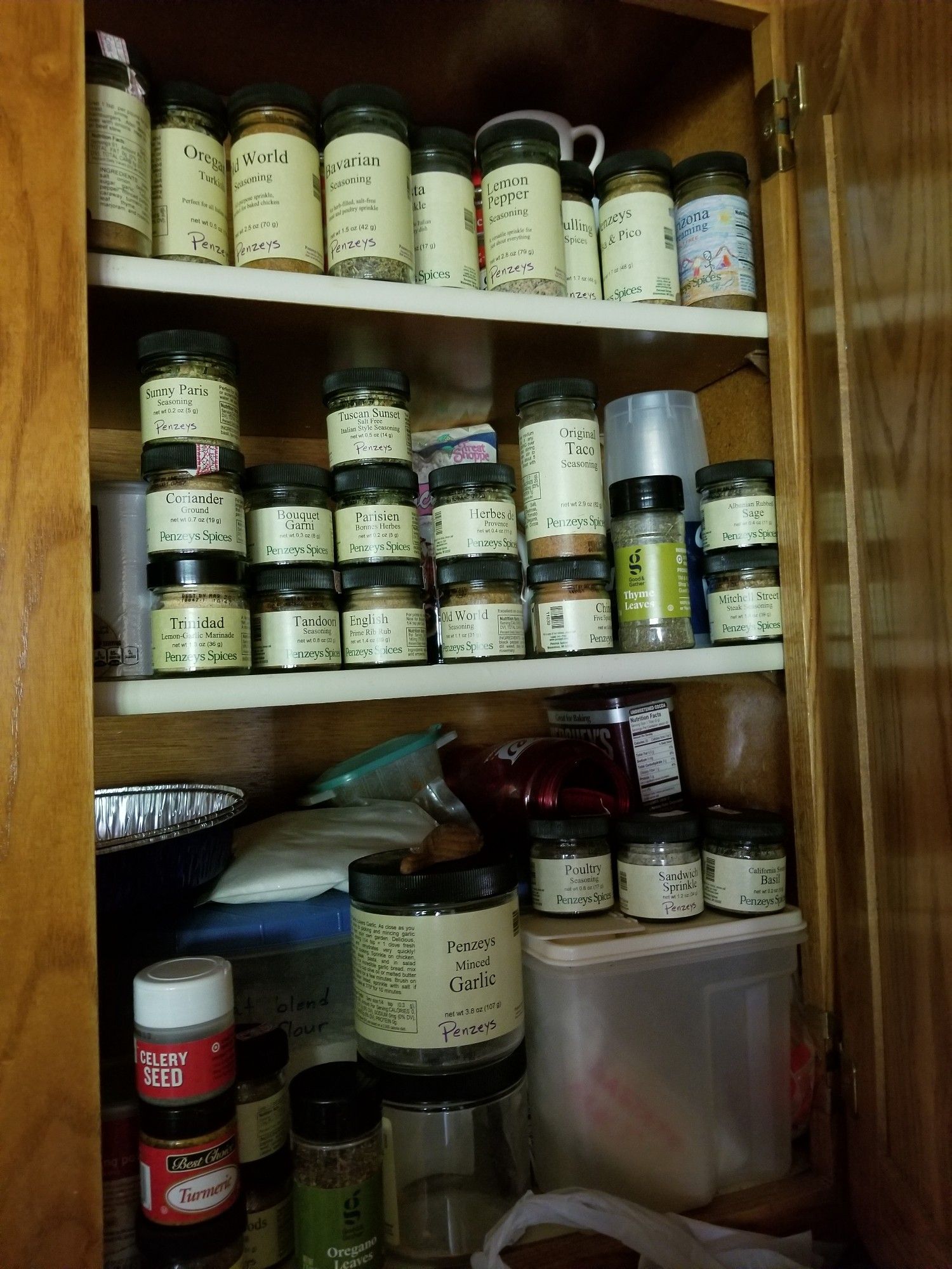 A kitchen cabinet filled with Penzey's spices.