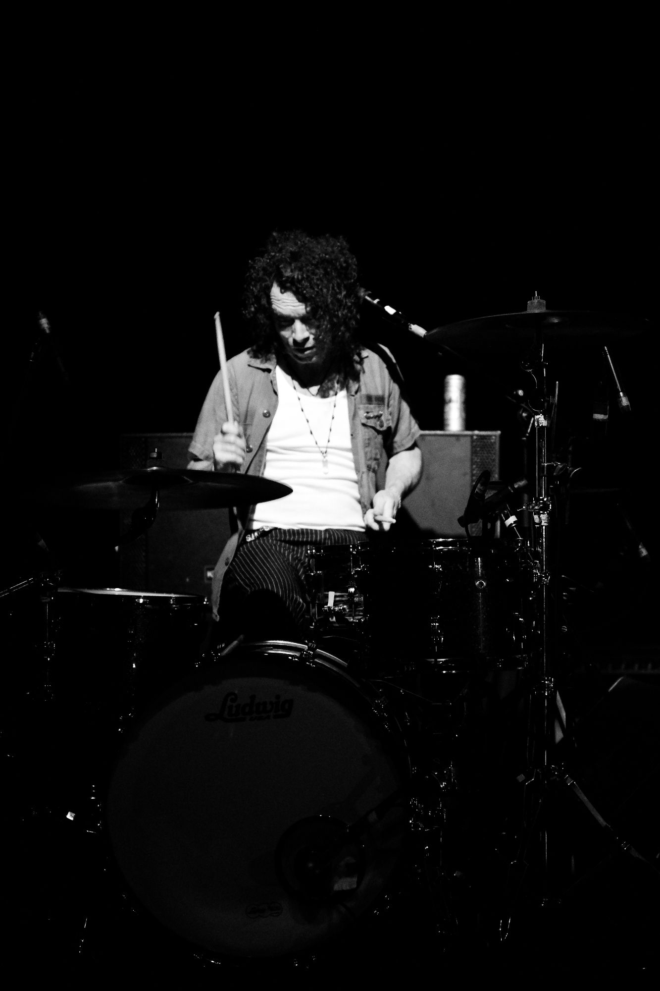 Black and white photo of Brent on stage behind his drum kit.