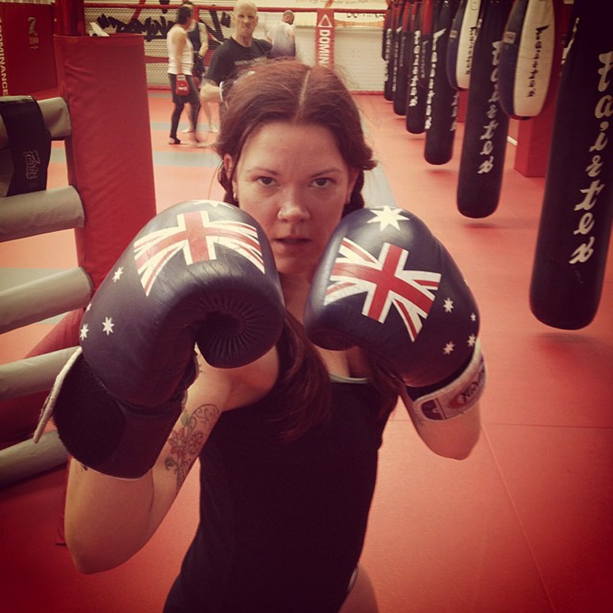 zia mccabe in a boxing pose with australia flag boxing gloves