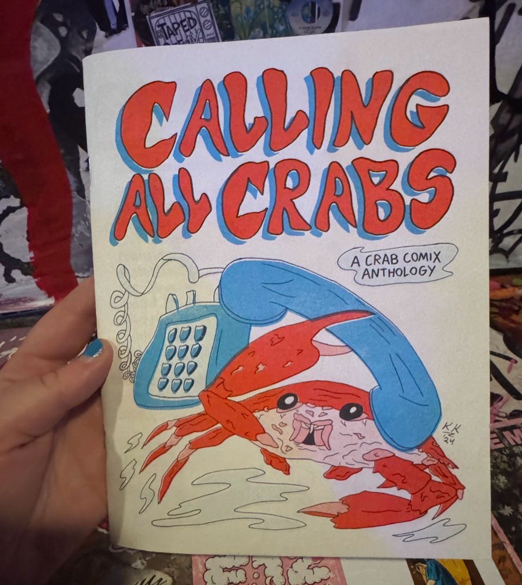 A comic book with a crab holding a phone on the cover titled “calling all crabs”