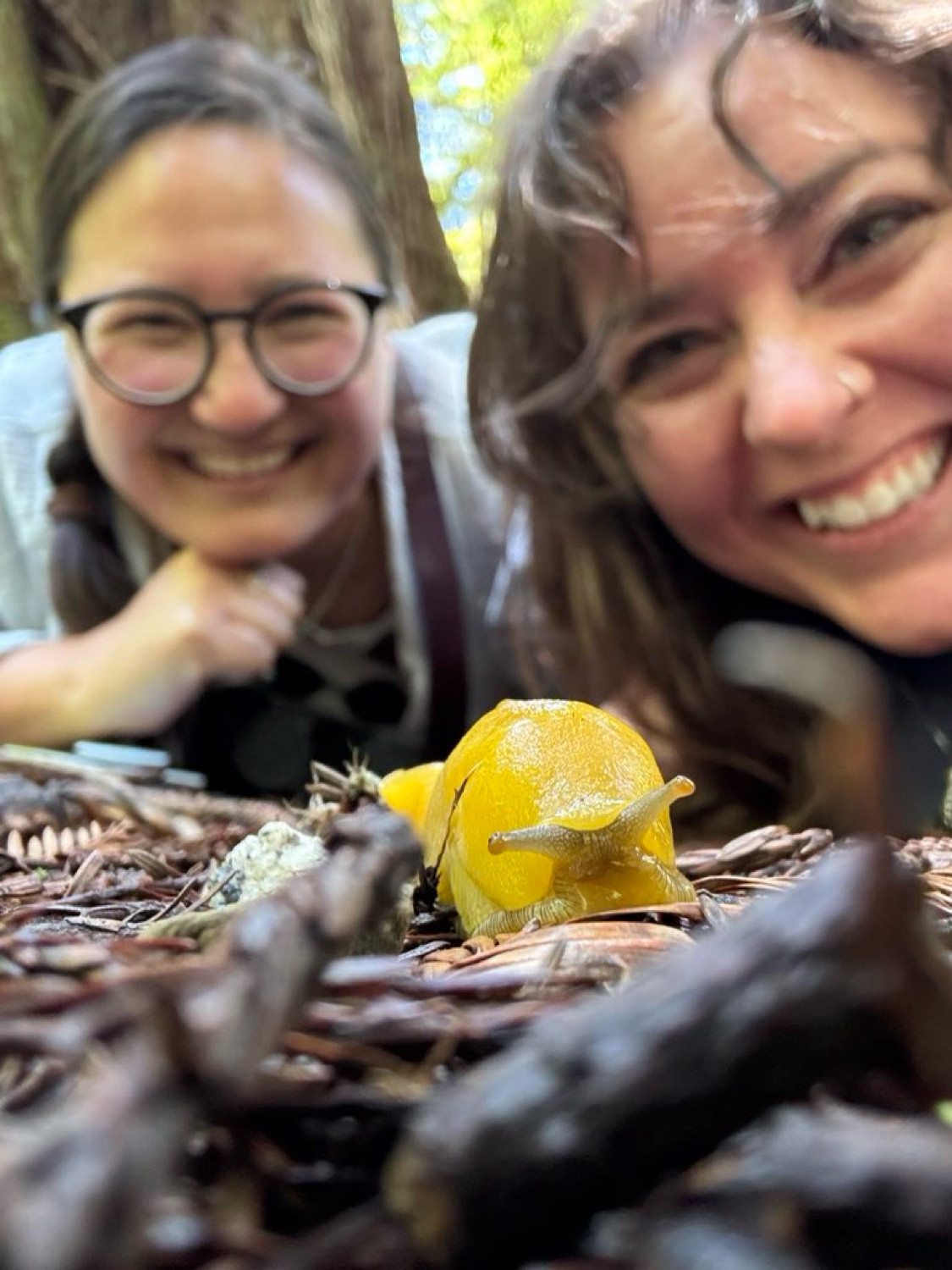 Sarah and Vicky are in the dirt with a very yellow slug