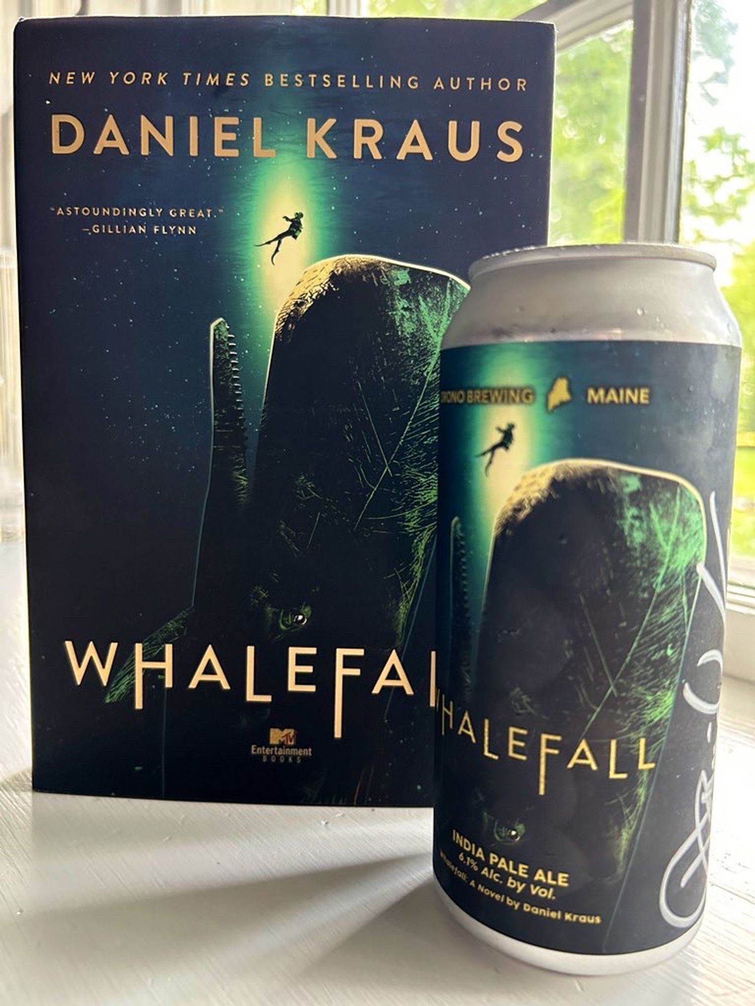 Whalefall book and Whalefall beer in front of a window