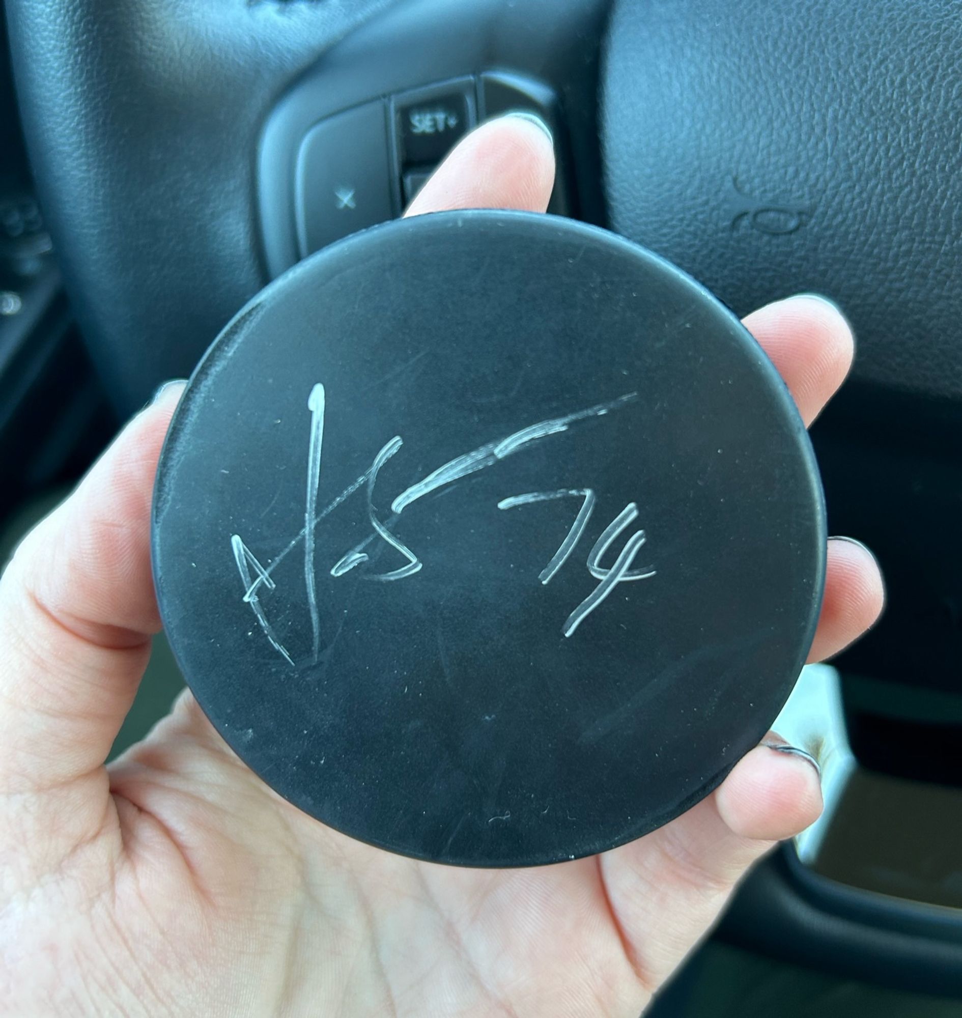 Puck autographed by Juuse Saros in silver sharpie.