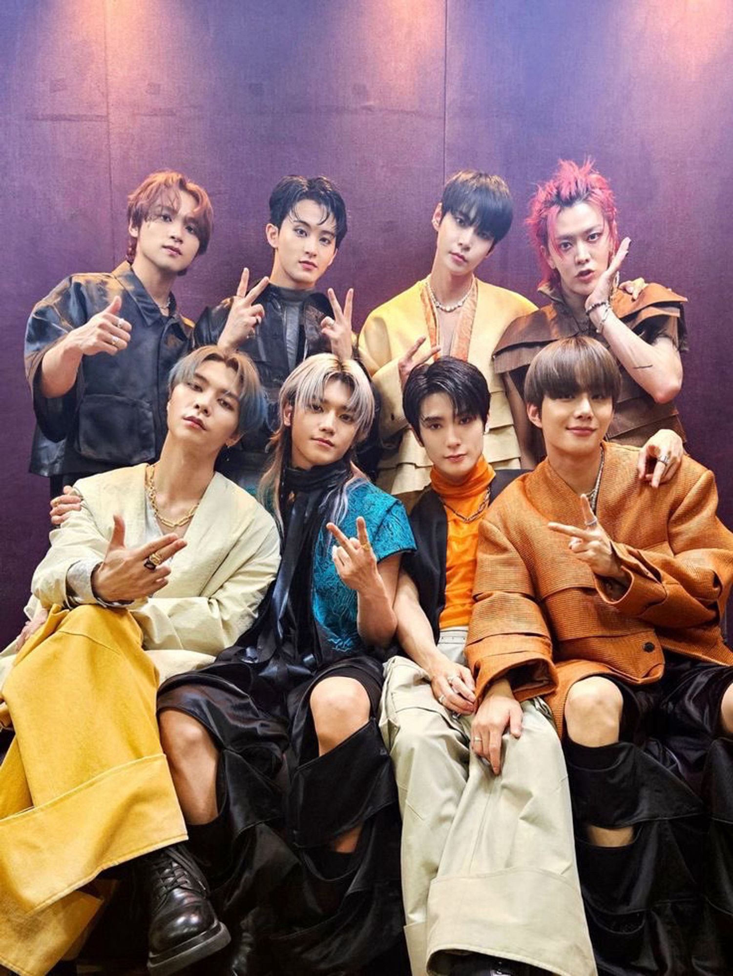 OT8 isle their modern traditional Korean outfits from Fact Check era. Johnny, Taeyong, Jaehyun, and Jungwoo are sitting. Haechan, Mark, Doyoung, and Yuta are standing behind them.