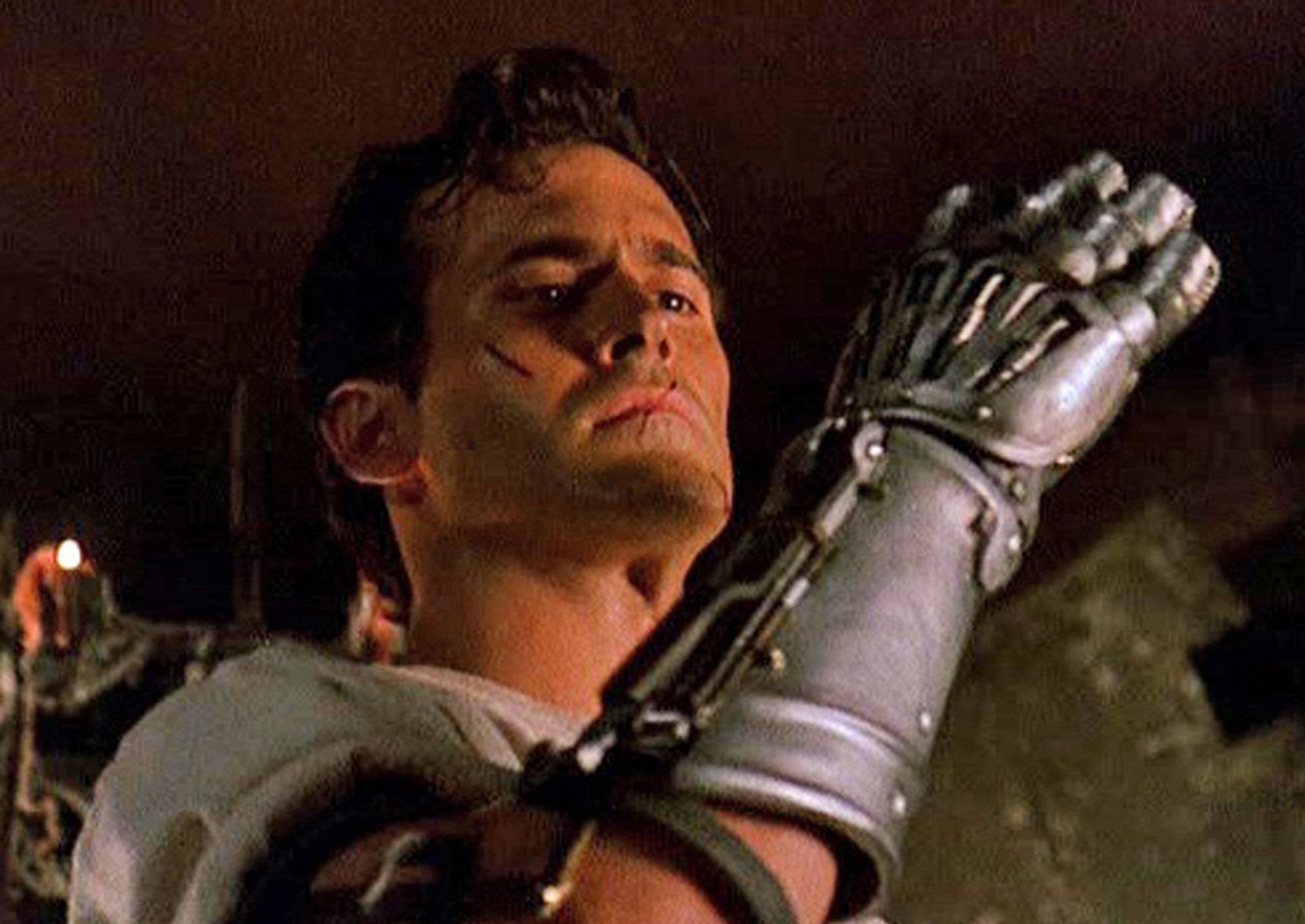 Ash from Army of Darkness equipped with prosthetic armored hand he has just finished constructing.