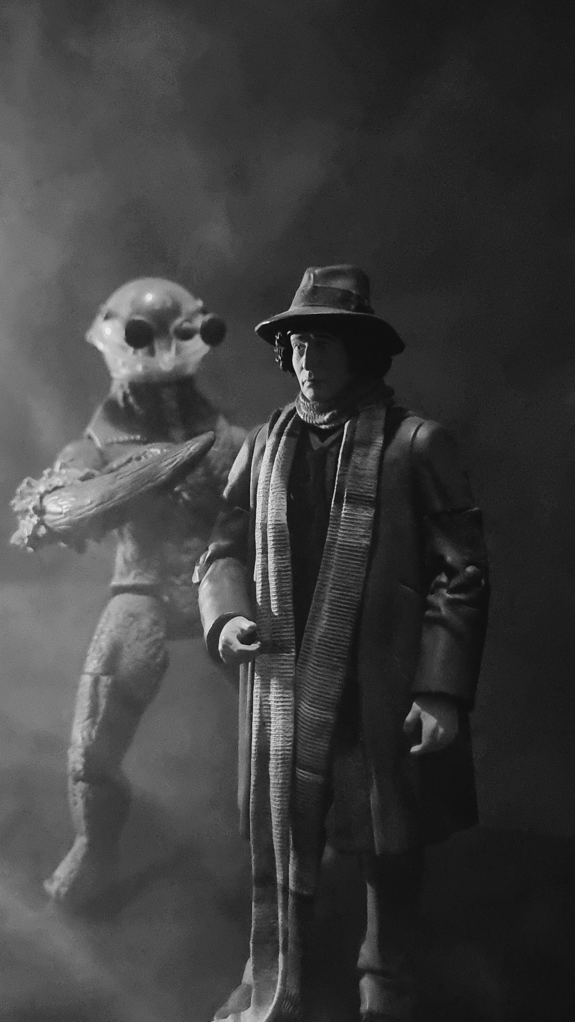 The fourth Doctor stands unaware of the presence of Morbius behind him. B/W image of Character Options Acrion Figures