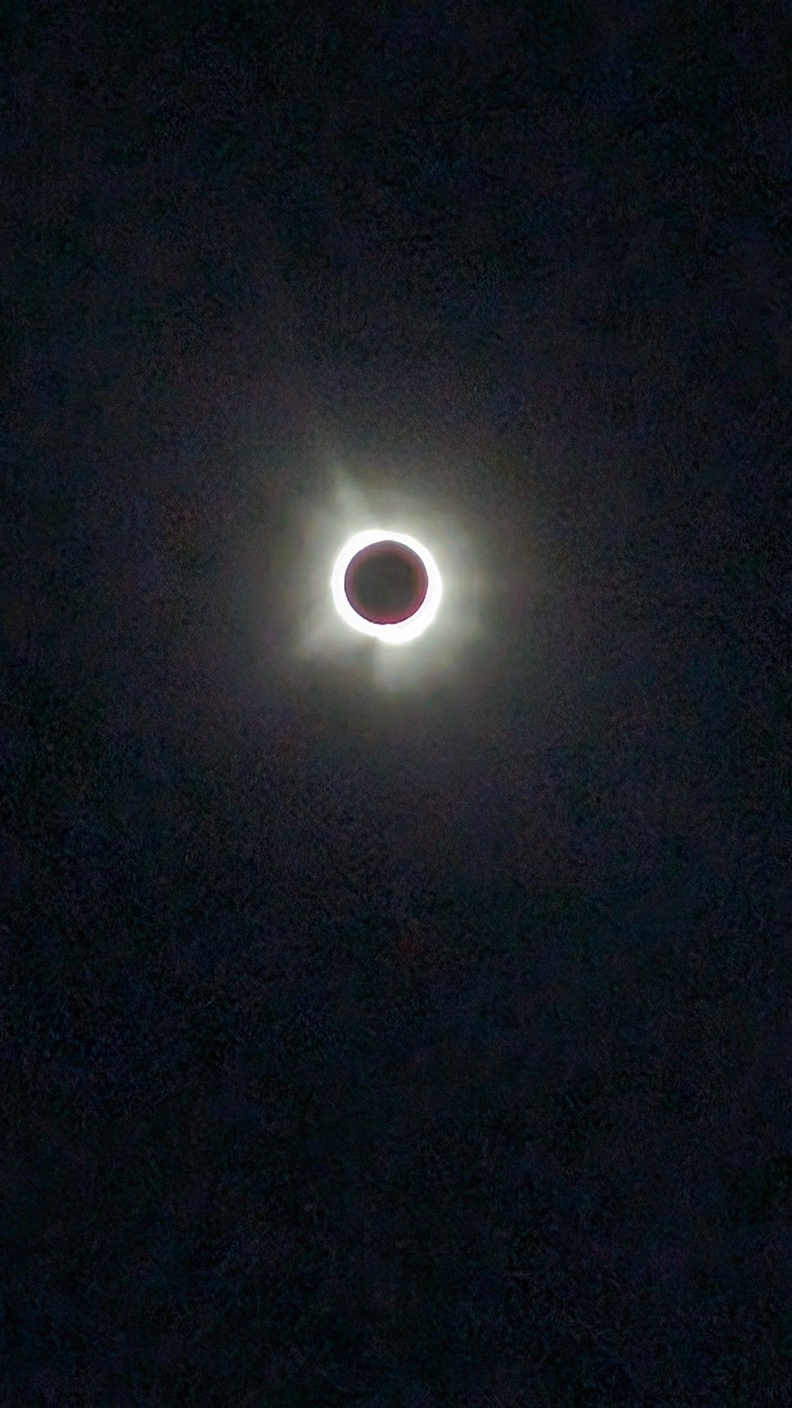 The sun's corona radiates out from the black moon shadow during the total solar eclipse.