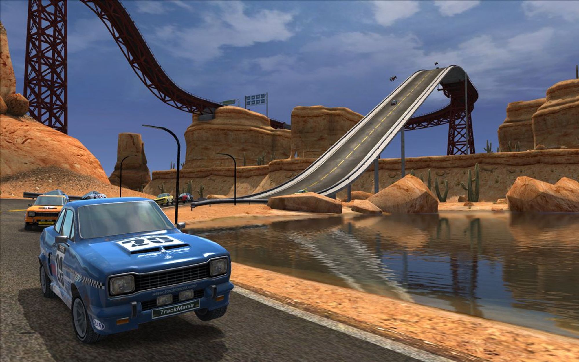 a blue car in a desert area, with other cars trailing behind it on a giant downwards slope. another one can be seen higher up in the distance. From Trackmania United Forever