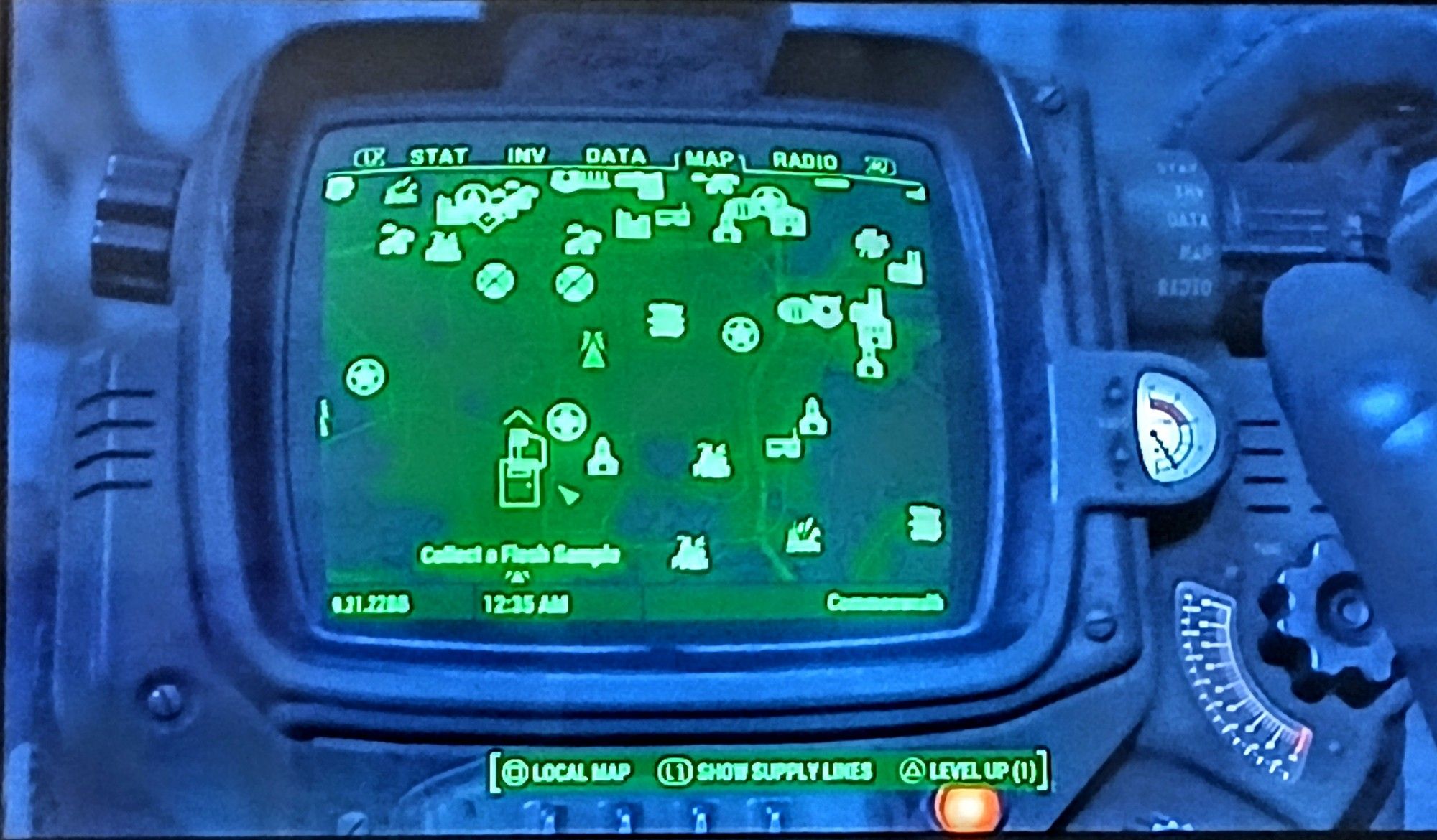 screenshot of a pip-boy map screen in the video game Fallout 4. It displays the standard navigation menu above the map, the date and time below the map, the surrounding outside unit of the pip-boy and a part of the right hand of the sole survivor off to the right side of the screen. At the bottom of the screen is a game menu for the local map, show supply lines, and to level up with one perk point available.