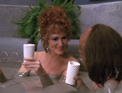 Lwaxana and Alexander enjoy a mud bath, unlike Worf.