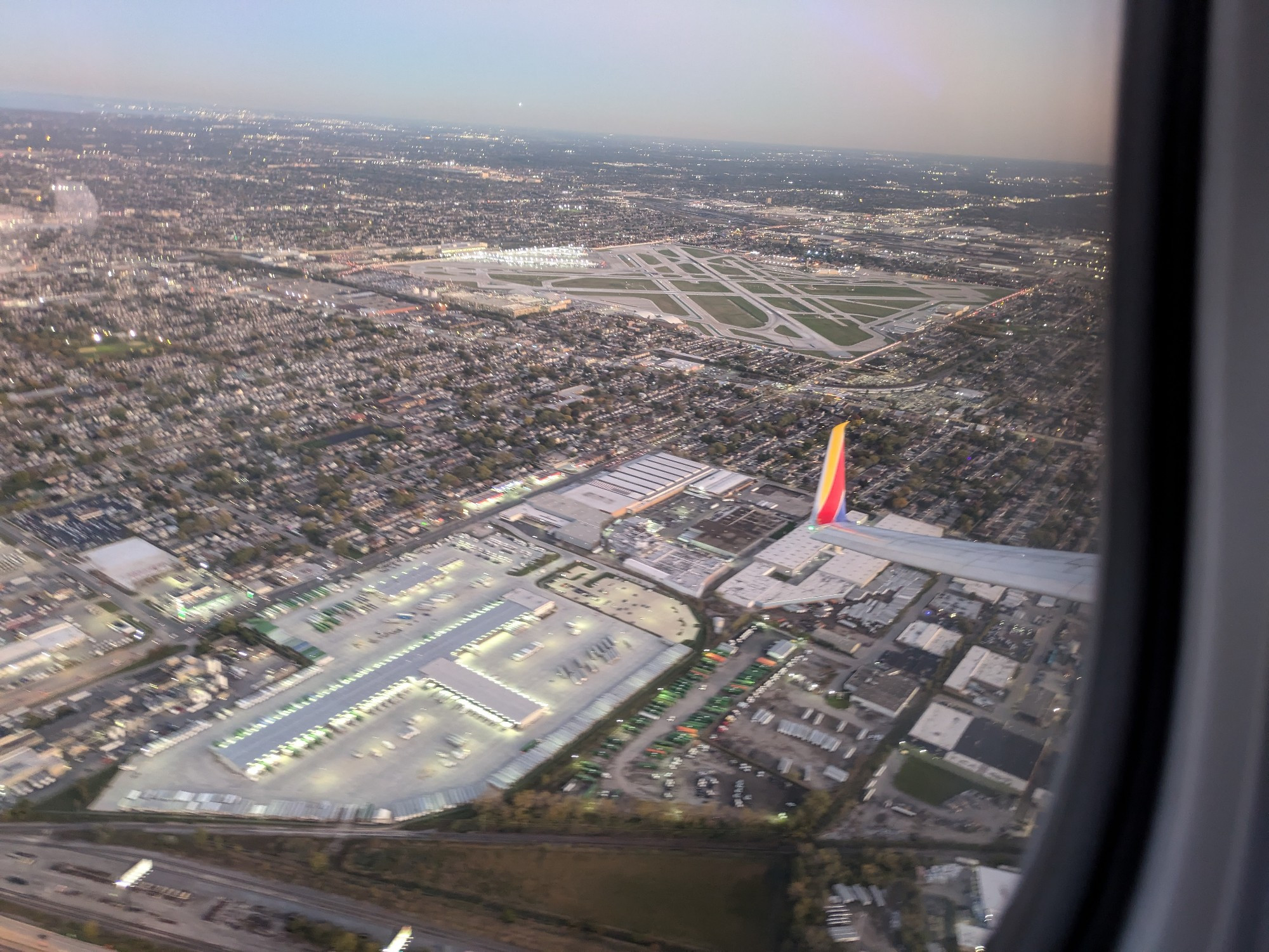 Looking down at an airport and surrounding city from above 