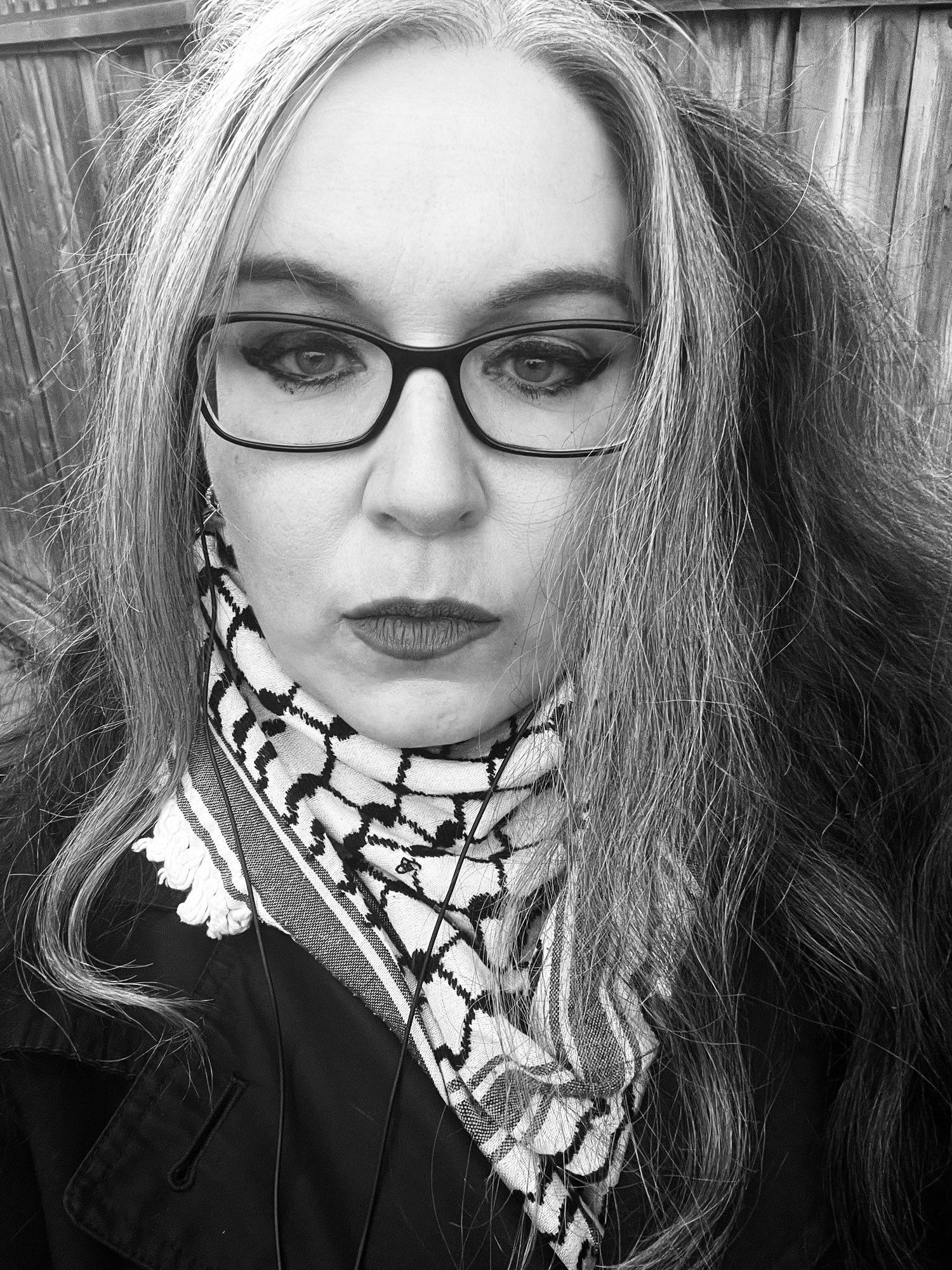 Black and white photo of me with my keffiyeh.
I used to collect keffiyeh's because many MENA countries have different styles of them. I had ones from Lebanon, Libya, Jordan, Palestine, and Qatar.
Ive given most away but Ive kept the ones from Jordan (it was my first) and the one from Palestine.