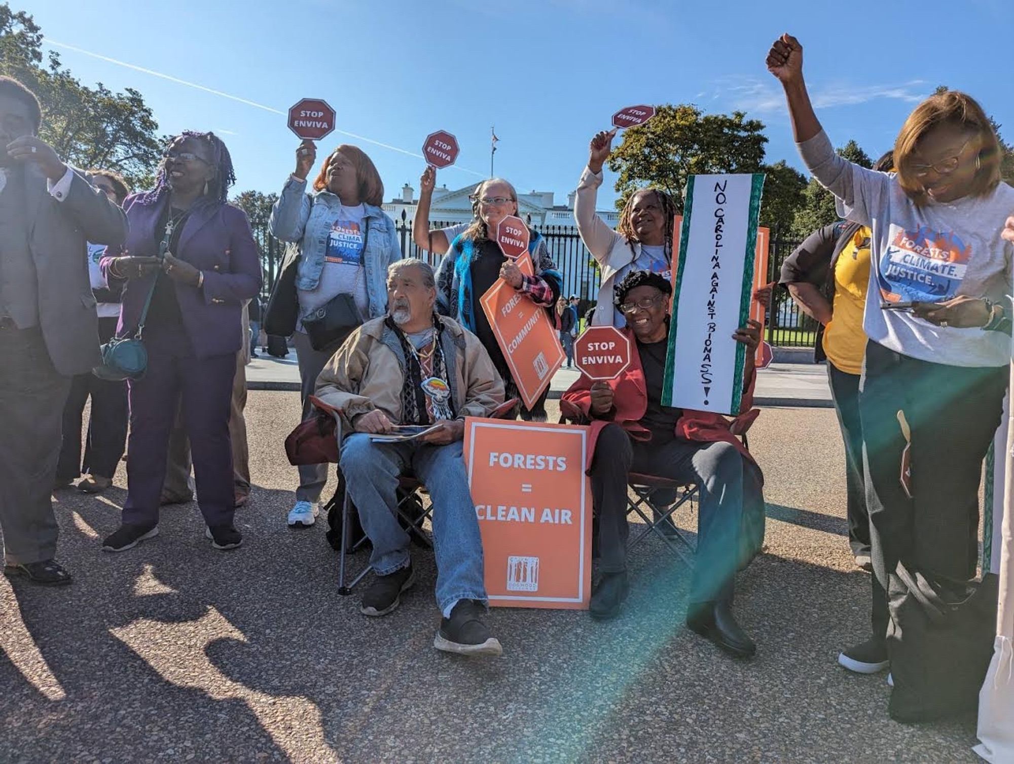 Photos of protest in front of the White House with impacted communities from Alabama, Mississippi, Georgia, North Carolina and South Carolina holding signs that read "Biomass = Injustice and "Clean Air is a Human Right". Also photos of petition delivery at Wilkinson office with photo of petition in box with wood pellets and members of Stand in front of the office with a smoking box with the Drax logo on it reading "BURNING FORESTS IS NOT A CLIMATE SOLUTION" and "CANADA: REJECT FOREST BIOMASS".