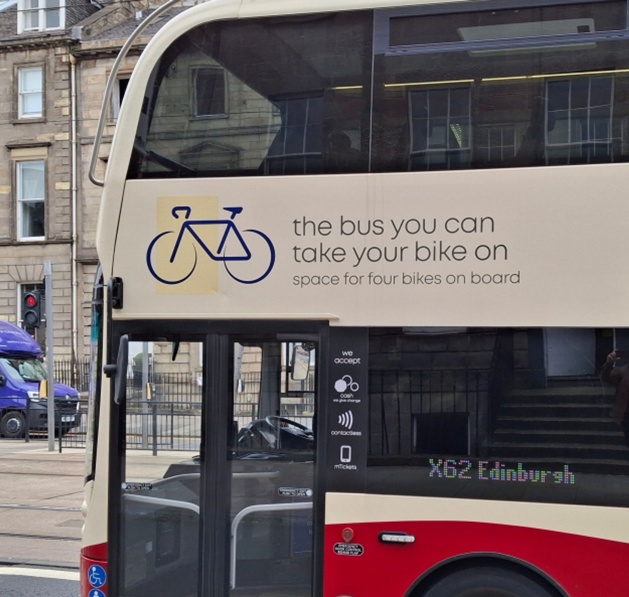 Sign on the side on a bus "the bus you  can take your bike on - space for four bikes on board."