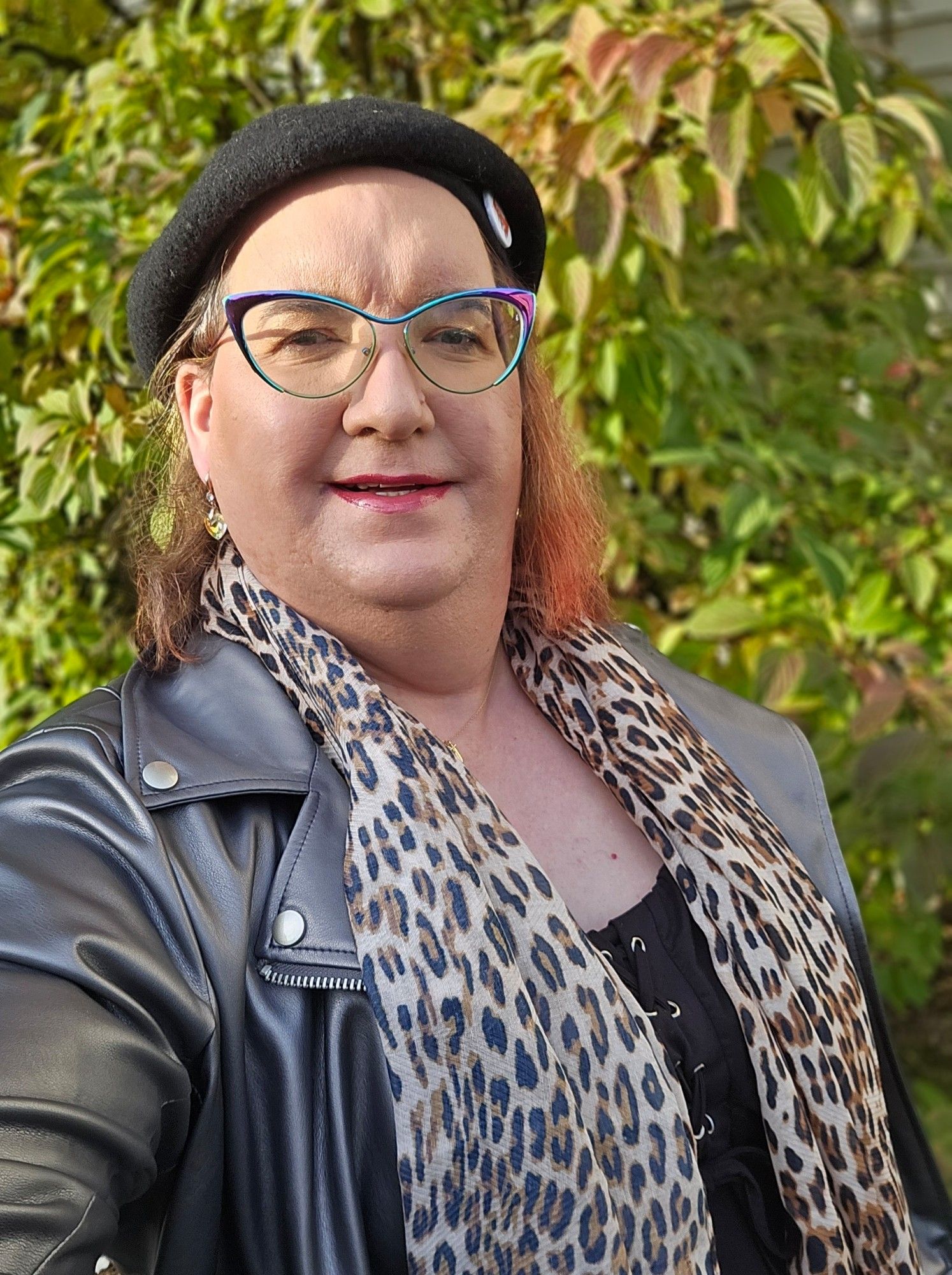 Selfie. Black beret.  Glasses. Silver faux leather jacket.  Black dress.  Leopard print scarf. I tossed some more colour in my hair