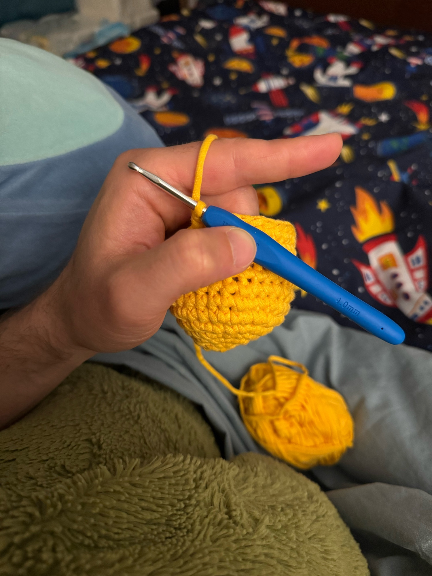 Crocheting an amigurumi with yellow yarn