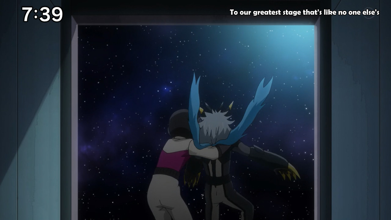 A screenshot from the Yu-Gi-Oh! SEVENS anime, taken from episode 92. In it are Luke and Kirishima Romin; Romin is standing at the edge of the entrance to a spaceship, catching Luke as he is floating back down.
On the top right of the screen, the subtitles to the opening song read: "To our greatest stage that's like no one else's".