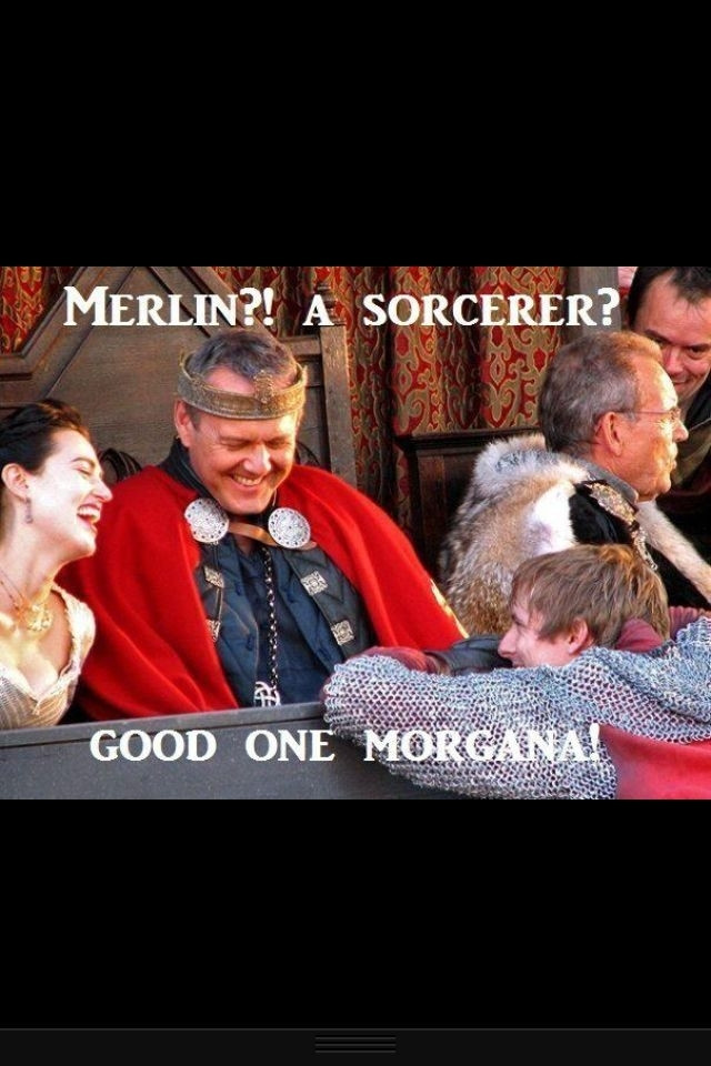 BBCs Merlin characters Morgana and Uther are seated behind a barrier, Arthur is leaning towards them on the barrier. All three characters are laughing. On the photo there is white writing reading 'Merlin? A socerer? Good one Morgana!'.