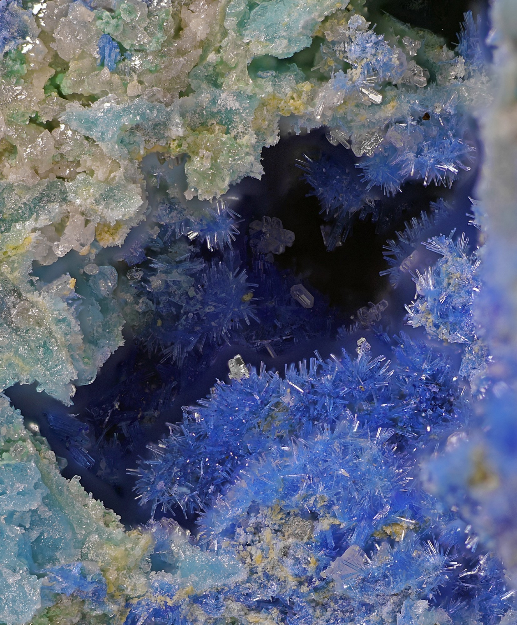 Close up of “grotto” crested by crusty oceanic pastels and opening into a bed of spiked blue linarite puffs onward into the dark.