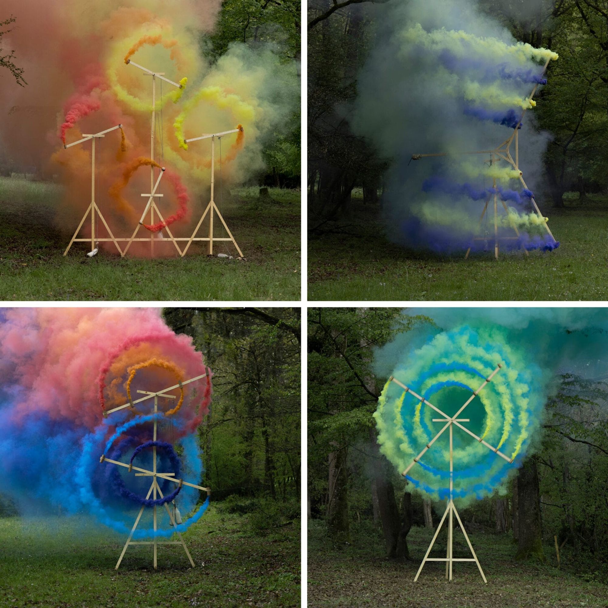 Four spinning wooden contraptions that emit spirals of multicolored smoke.