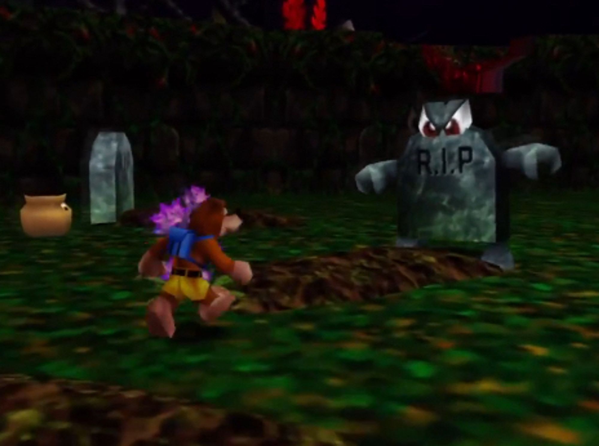 Banjo-Kazooie running to wards an angry-looking sentient gravestone in a spooky graveyard in the Mad Monster Mansion level.