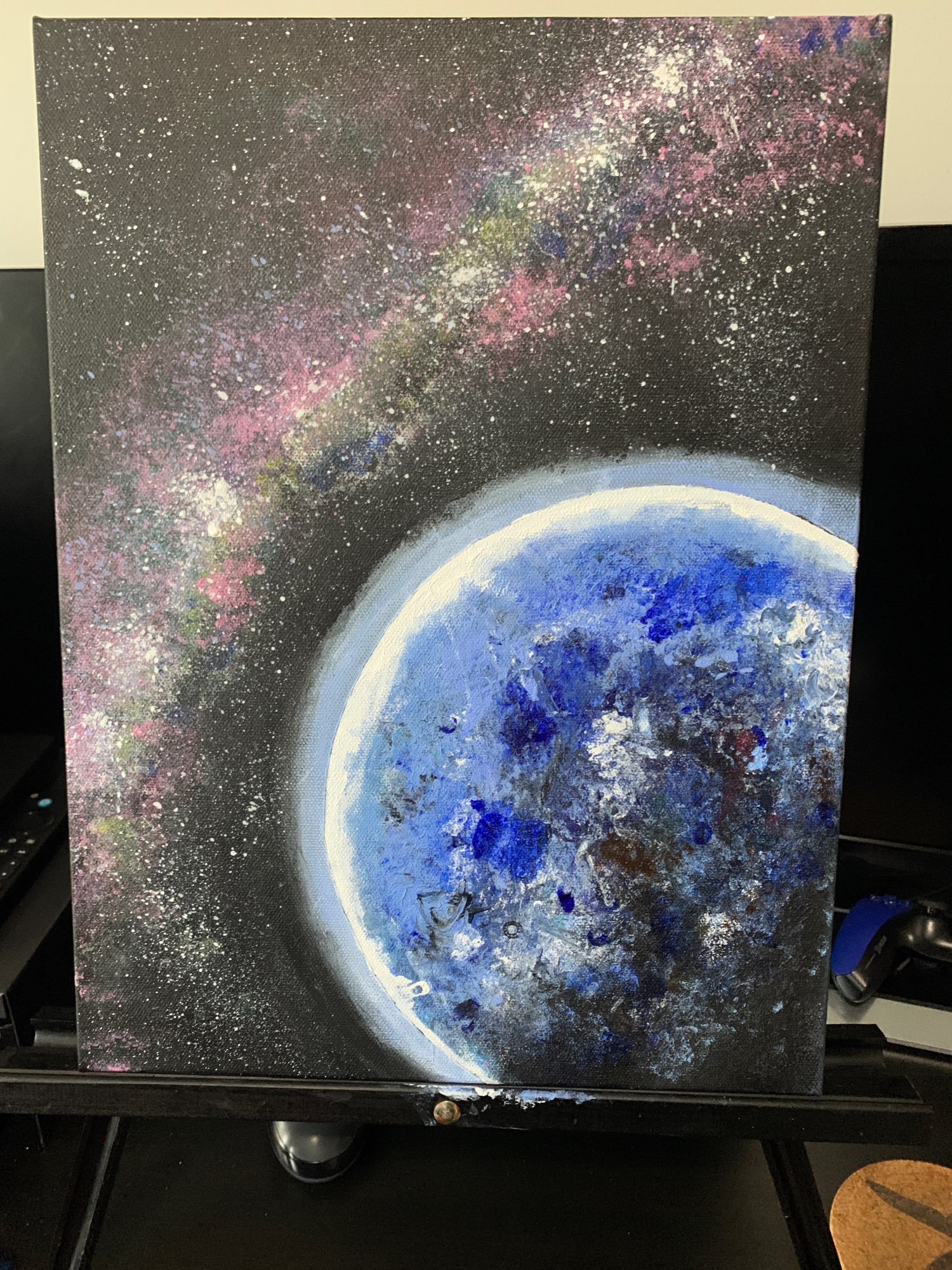 Acrylic painting on canvas of planet and galaxy.