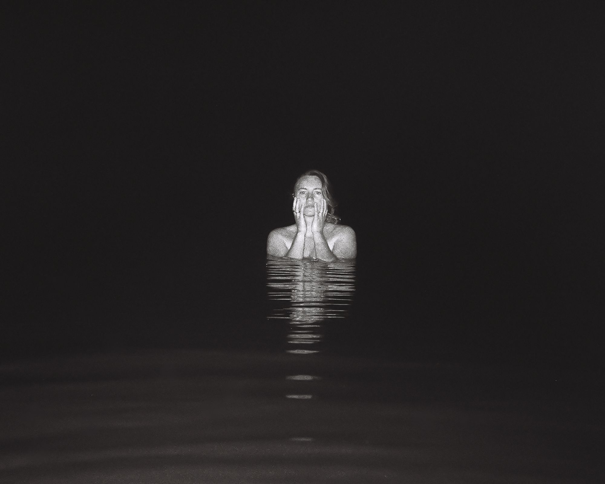 Carolyn Kendrick bobs in the dark water of a rural Maine pond. Spooky.