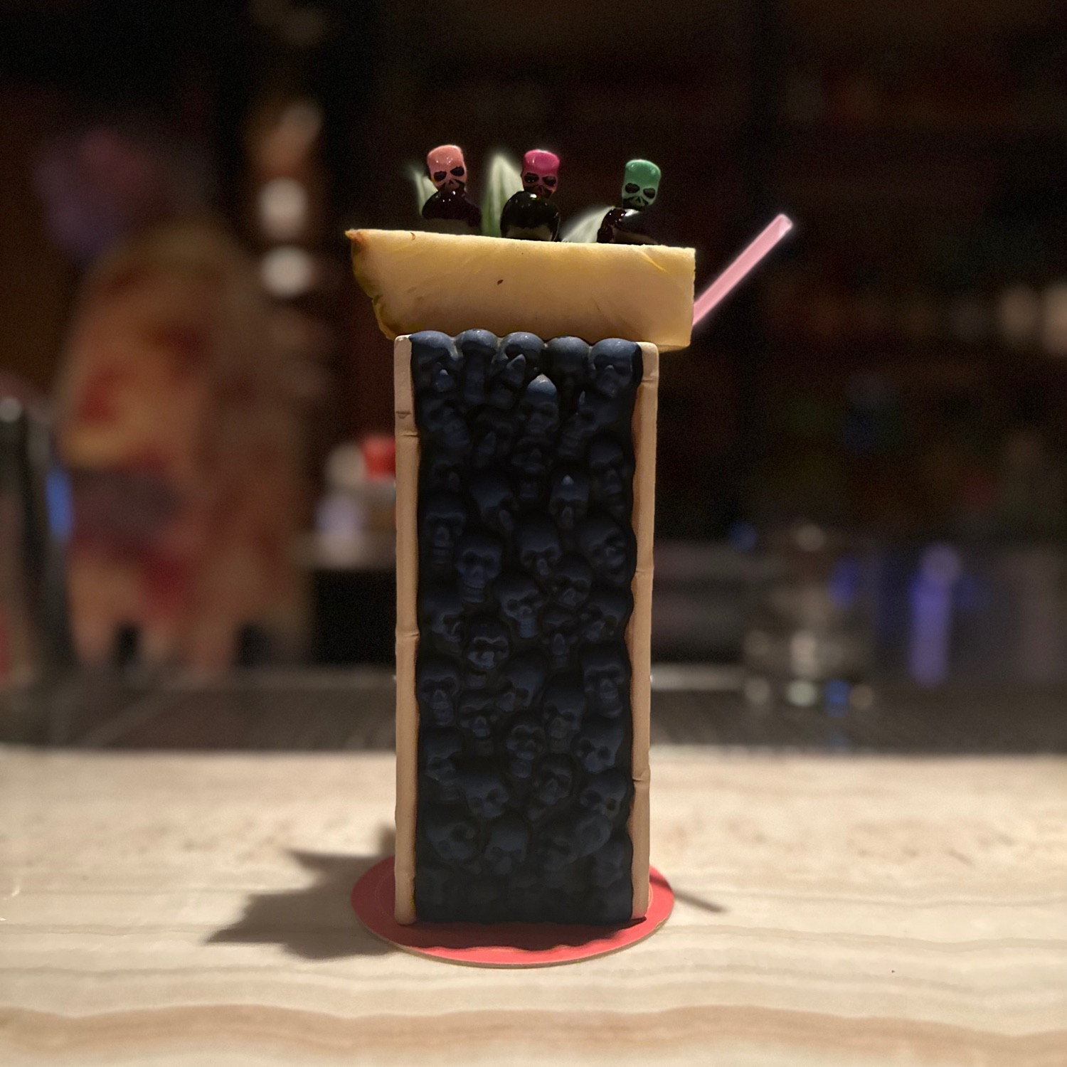 Cocktail served in a tiki mug designed to look like the wall of skulls