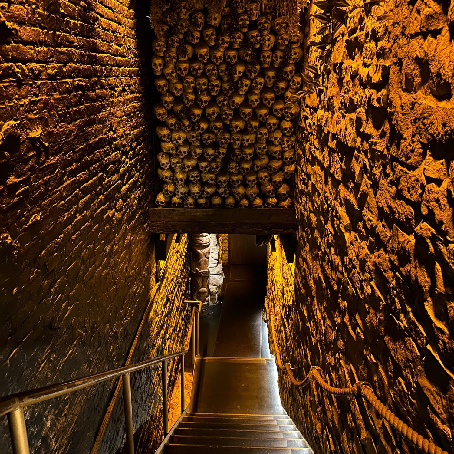 Stairway entrance with a wall of skulls overhead