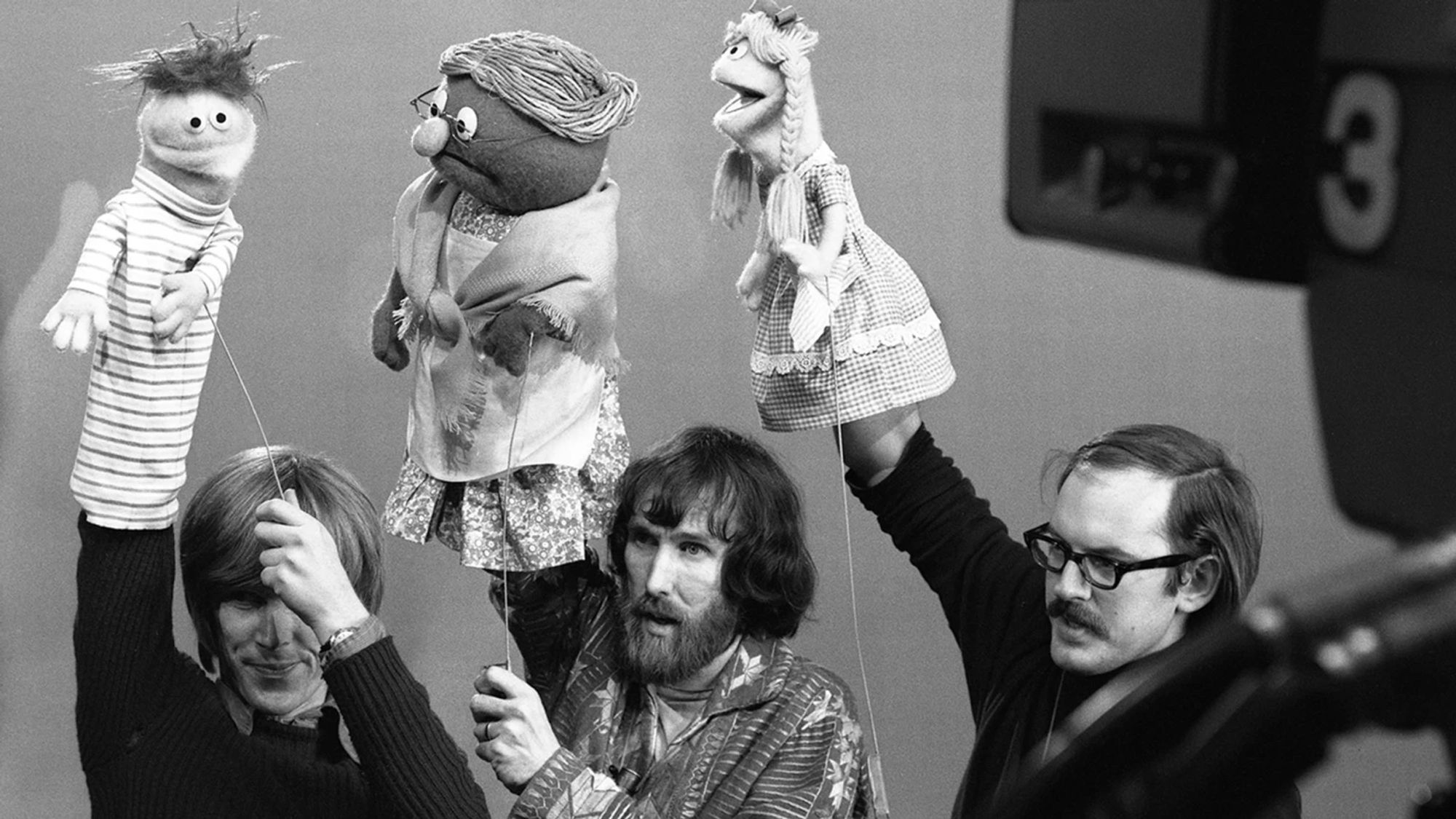 Vintage photo of three muppets with their muppeteers in frame