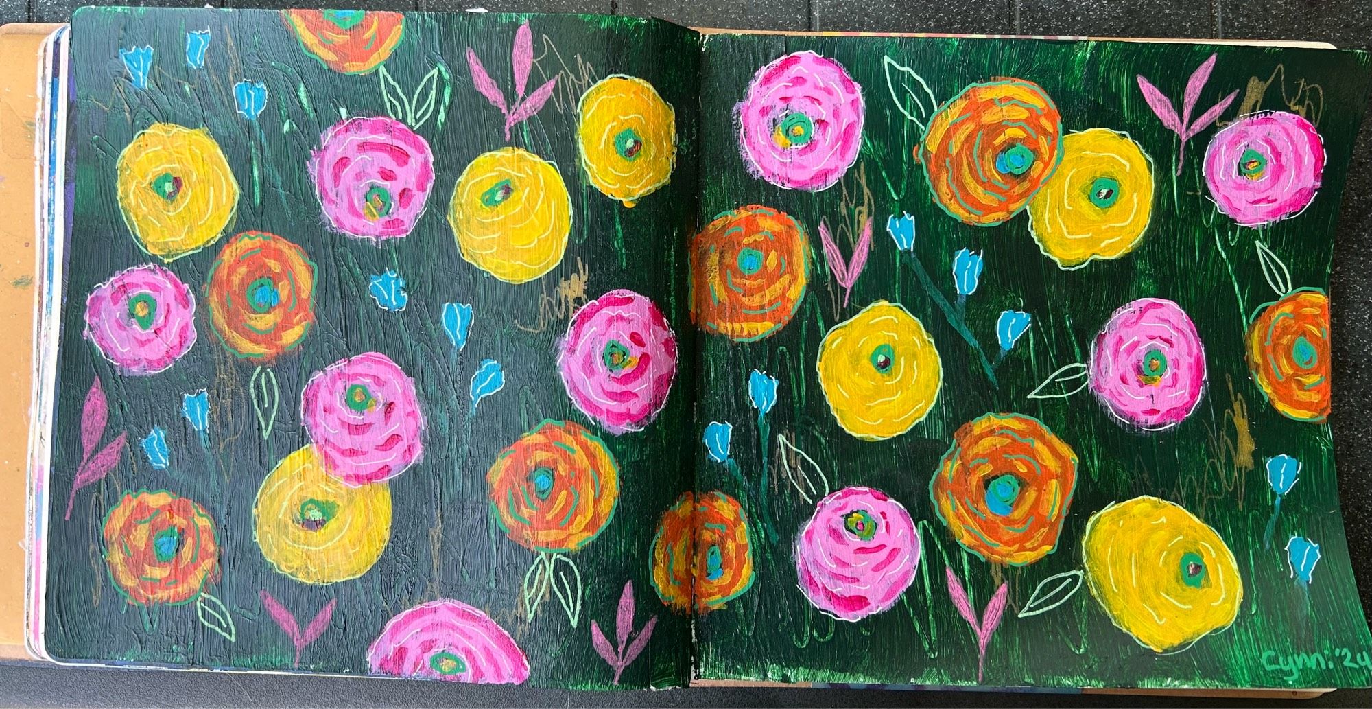 Pink, yellow and orange flowers on a dark green background