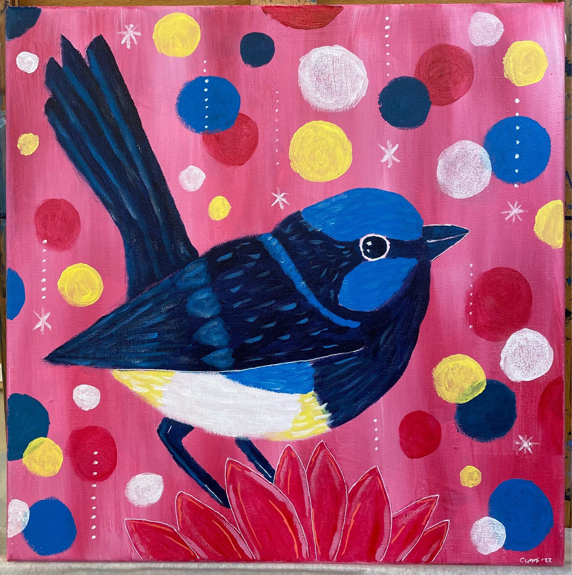 A blue bird on a pink background with colorful circles