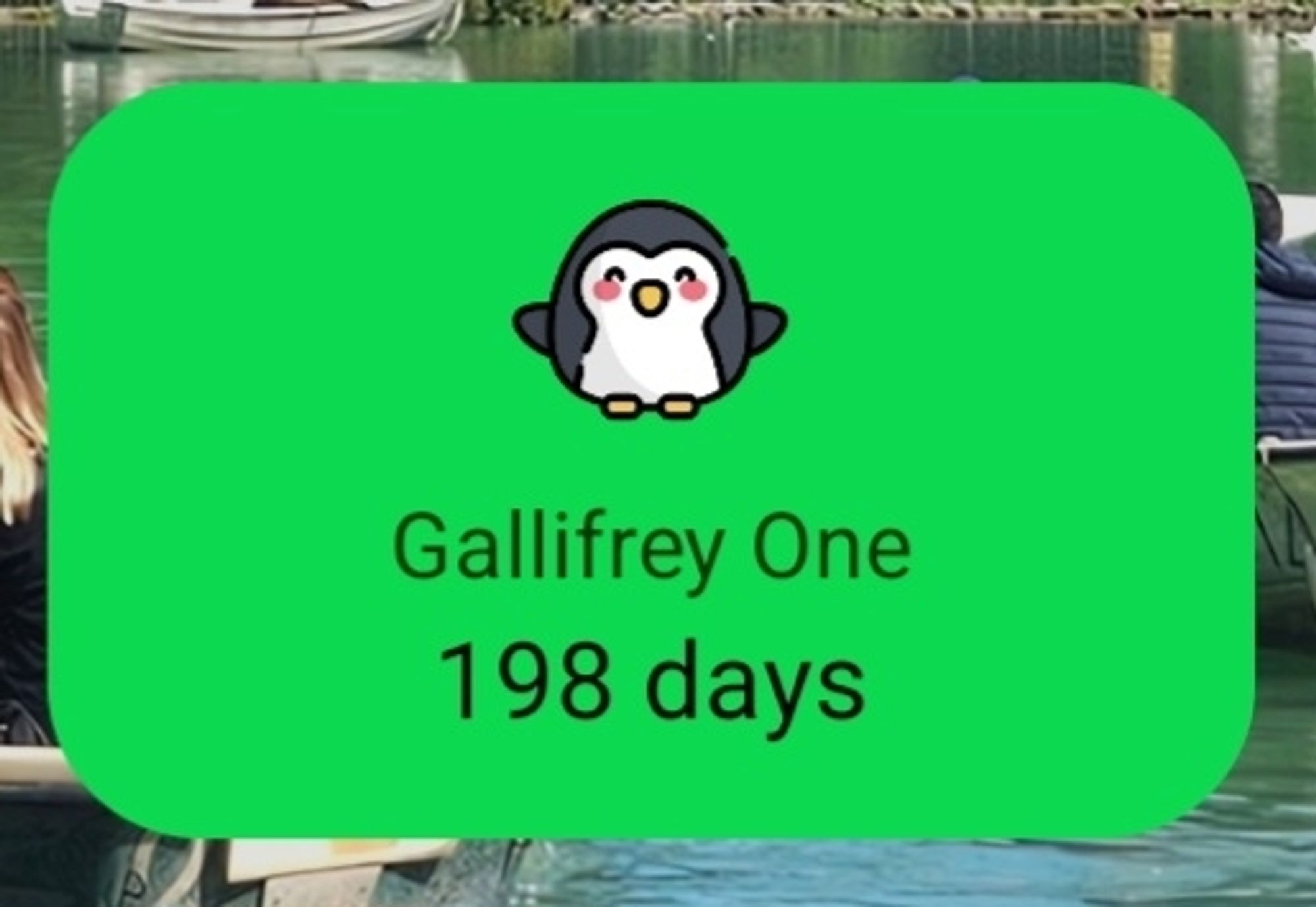 Cartoon penguin on green background with text "Gallifrey One 198 Days."