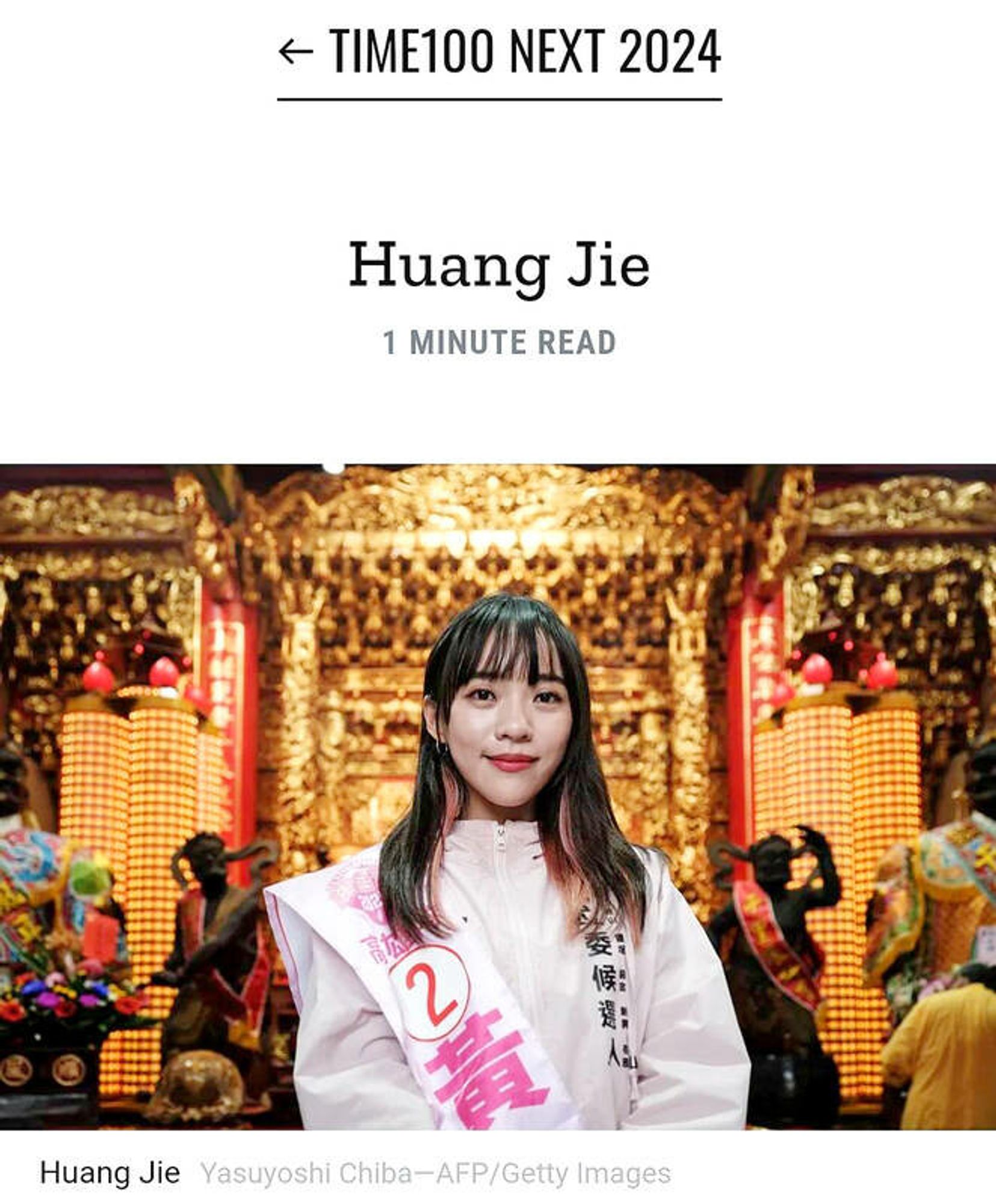 Huang Jie wearing a pink sash designating her as an electoral candidate standing in a Taiwanese temple with golden ornamentation