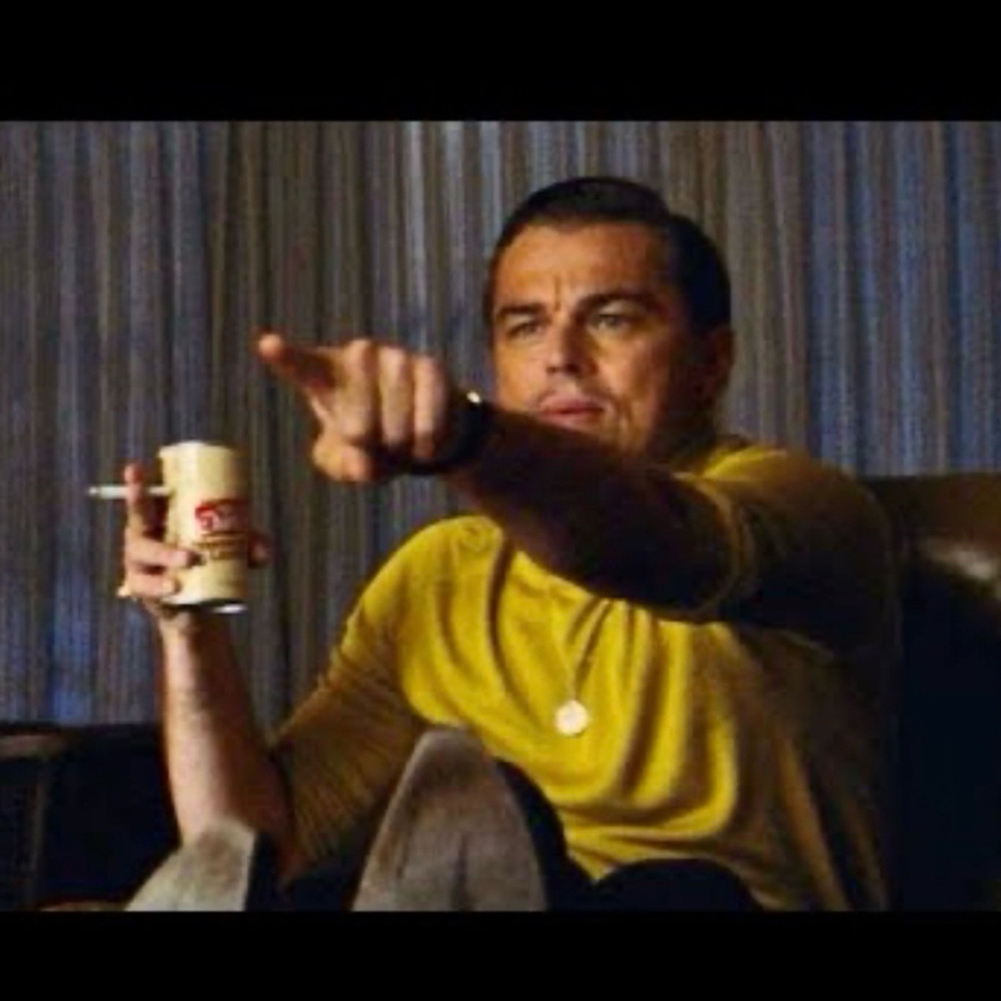 DiCaprio pointing meme from Once Upon A Time. It’s Leo holding a beer and a cigarette pointing at a tv off camera