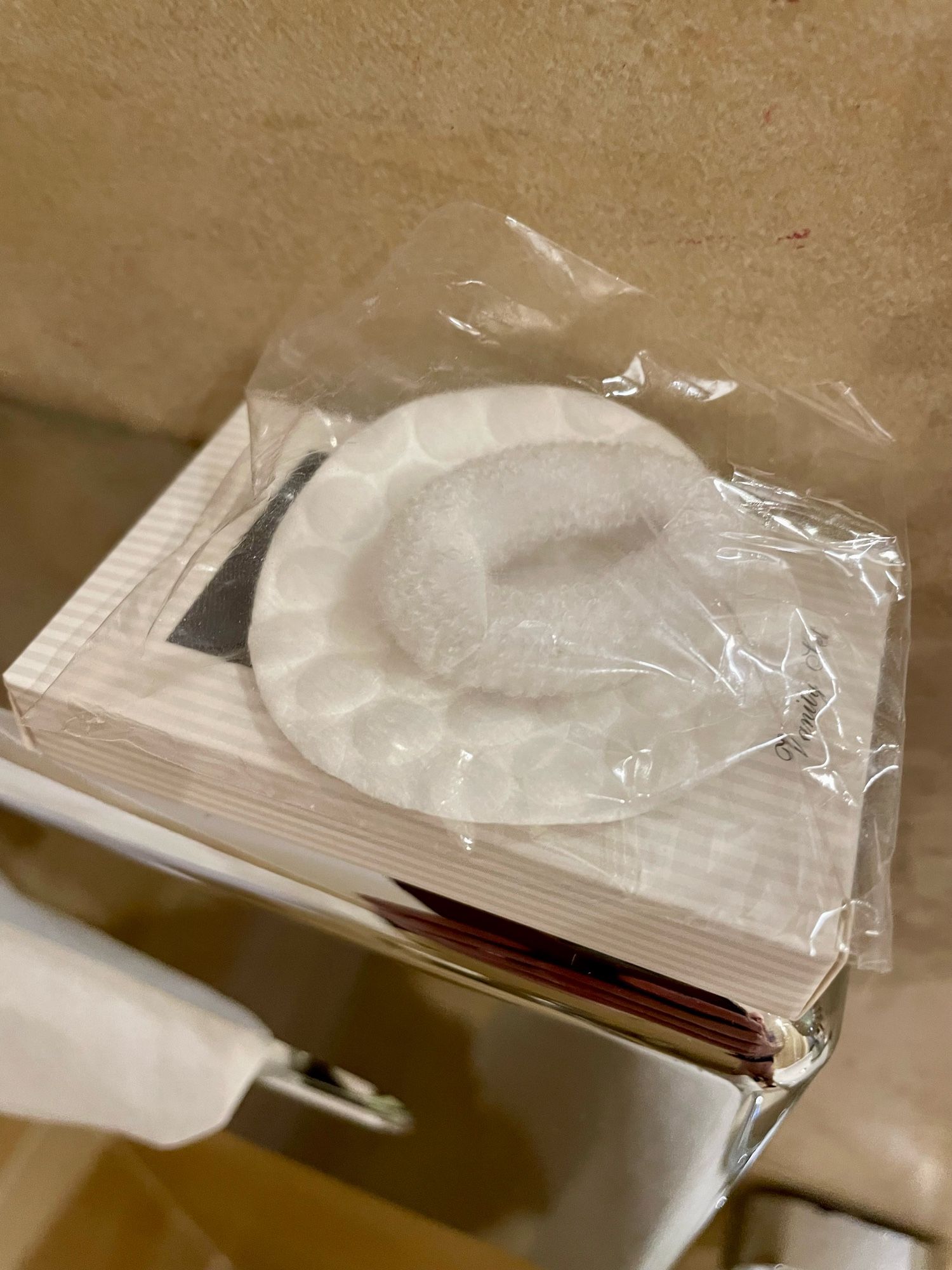 A hotel vanity pack including face pads and a soft fabric ring