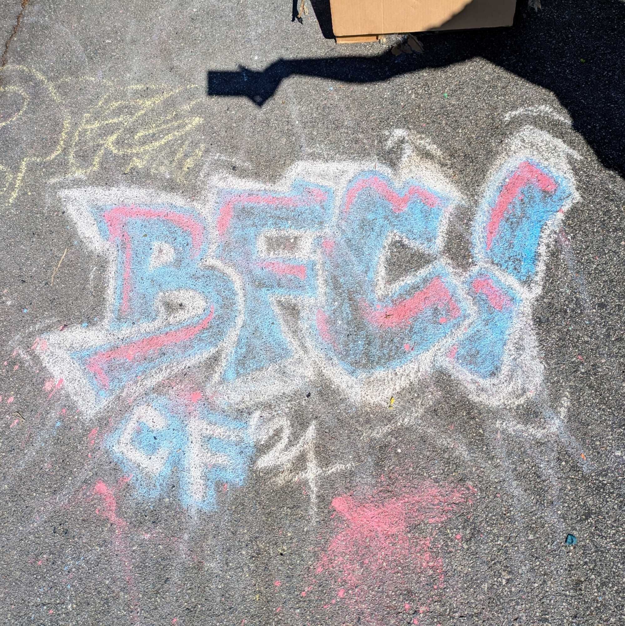 "BFC!" written in chalk on asphalt. It is written in graffiti style.