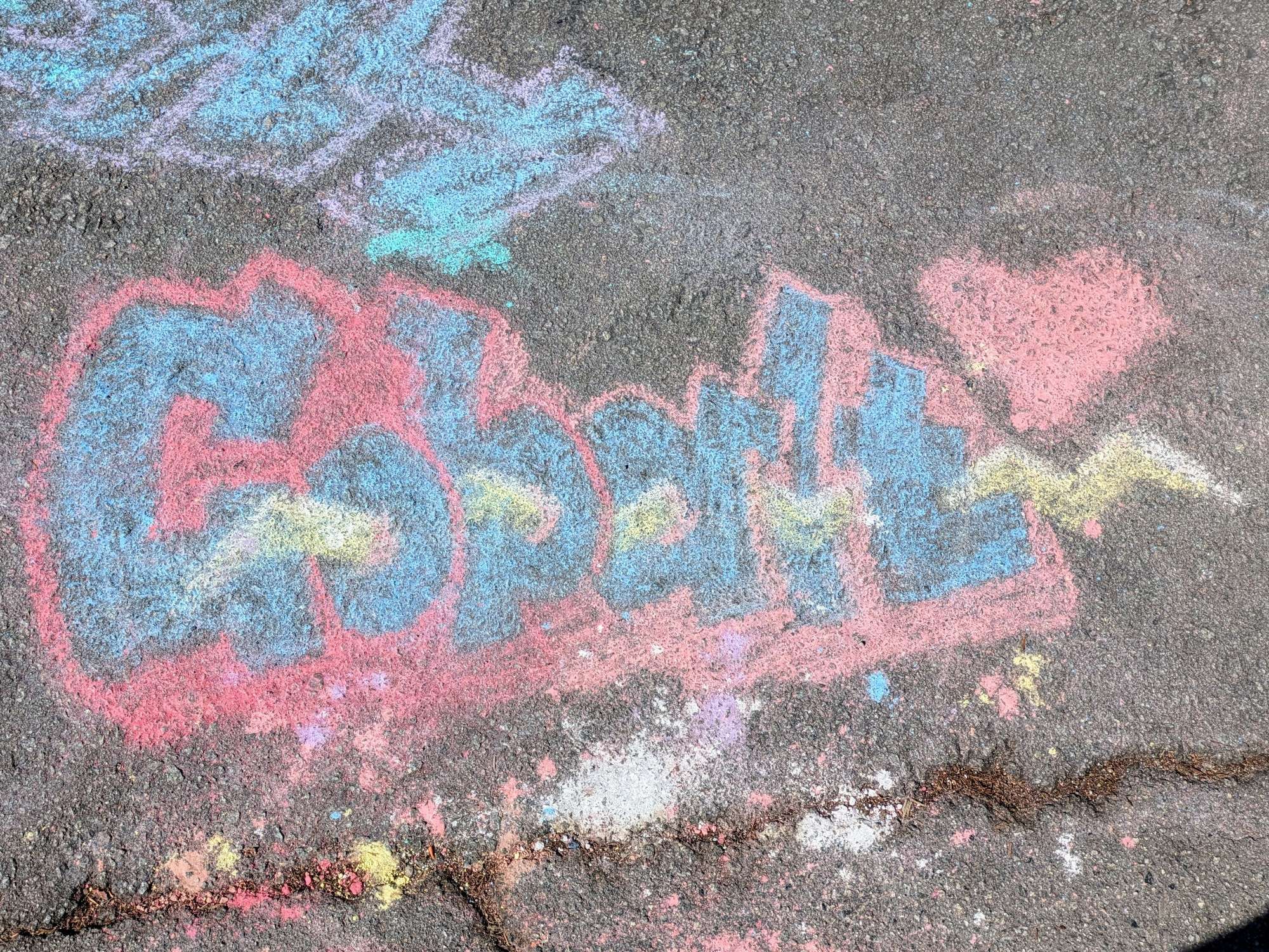 "Cobalt" written in chalk on asphalt. It is written in a serif graffiti style with a lightning accent.