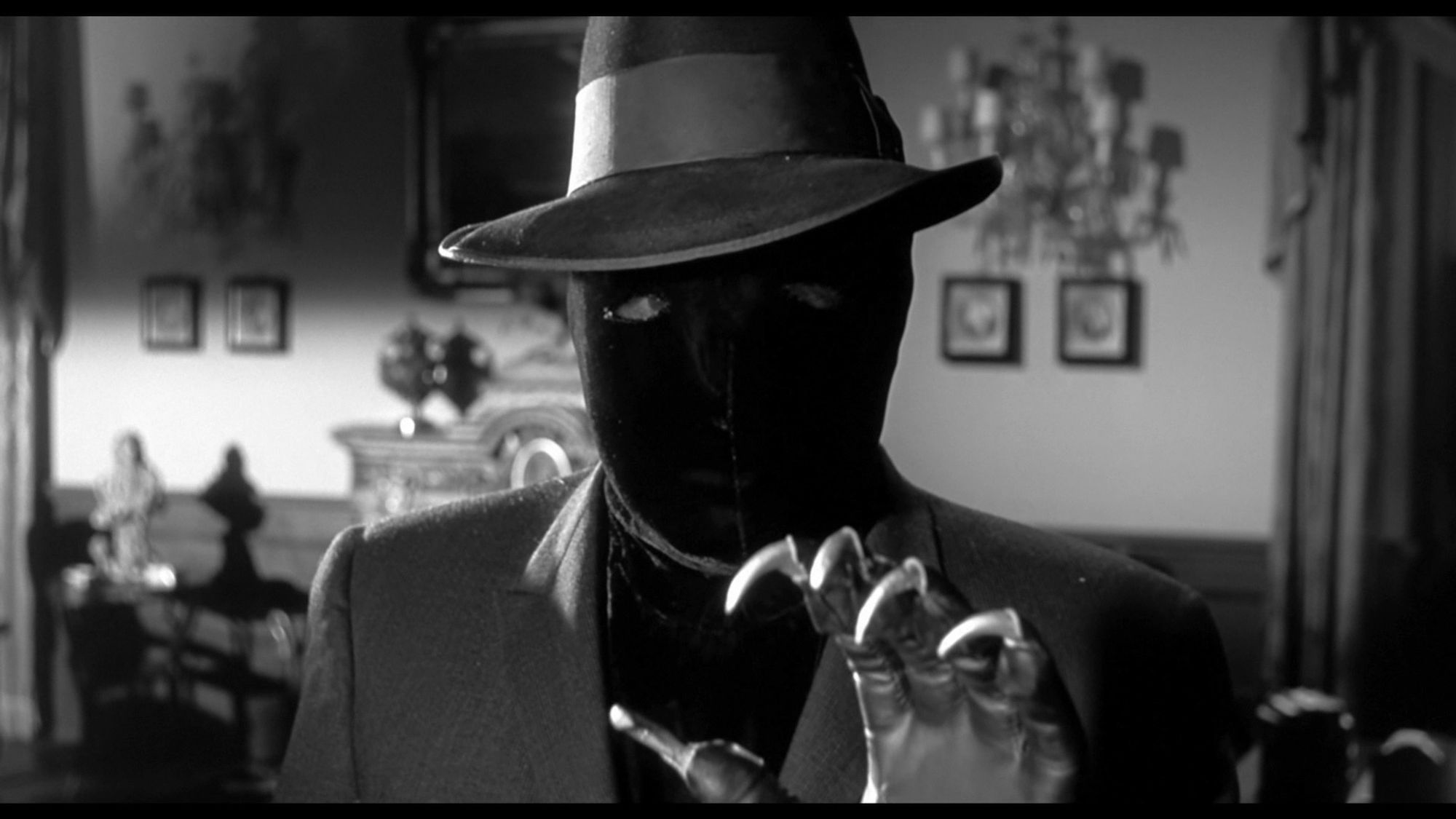 The masked killer from 1959's The Bat. He's got a fedora, black ski mask, and clawed glove. And he's looking right at you! Watch out! THE CREEPY GUY FROM THE 1959 PROTO-SLASHER THE BAT IS COMING TO GET YOU!