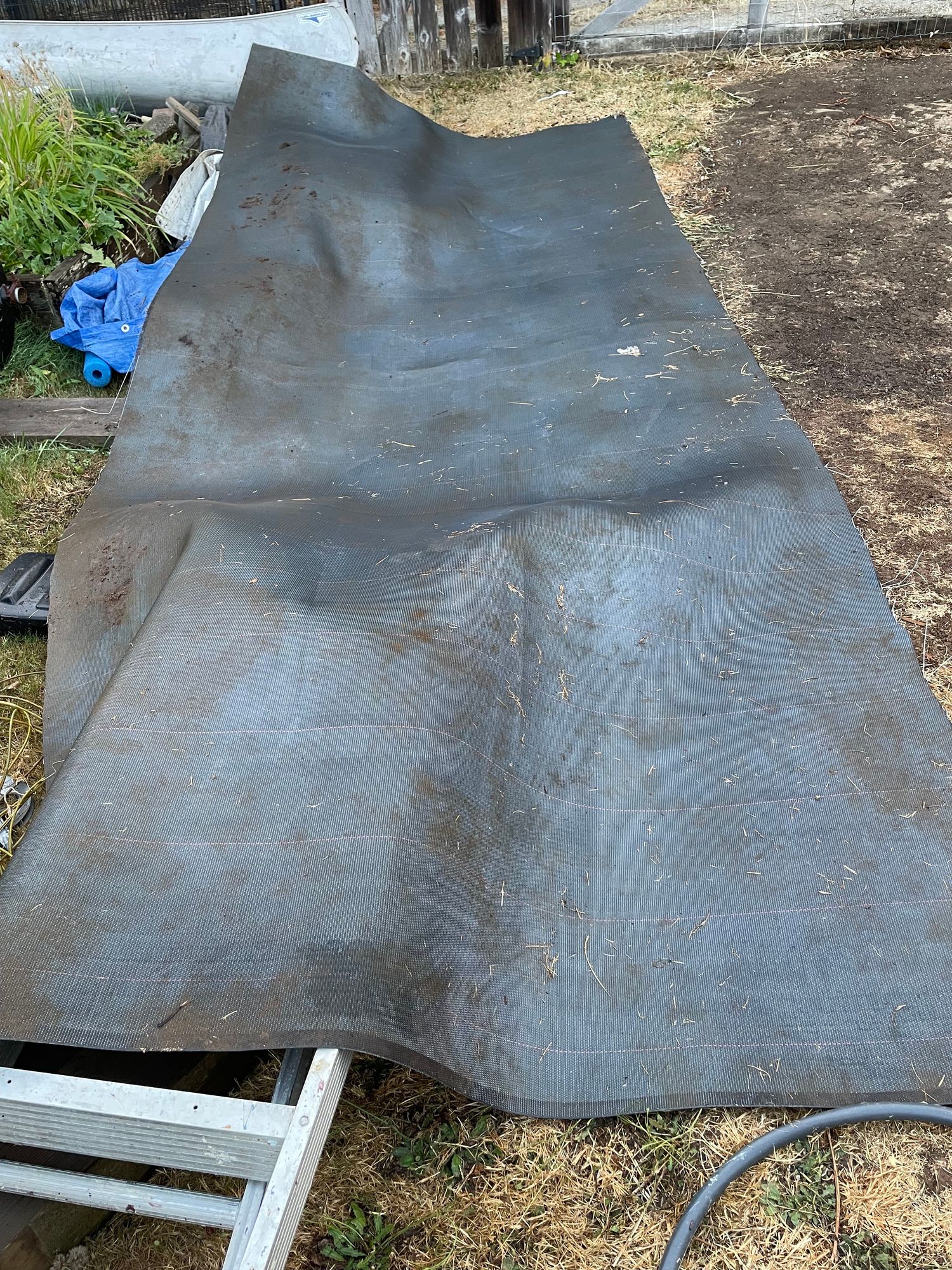 A large blue grey mat is on the ground 