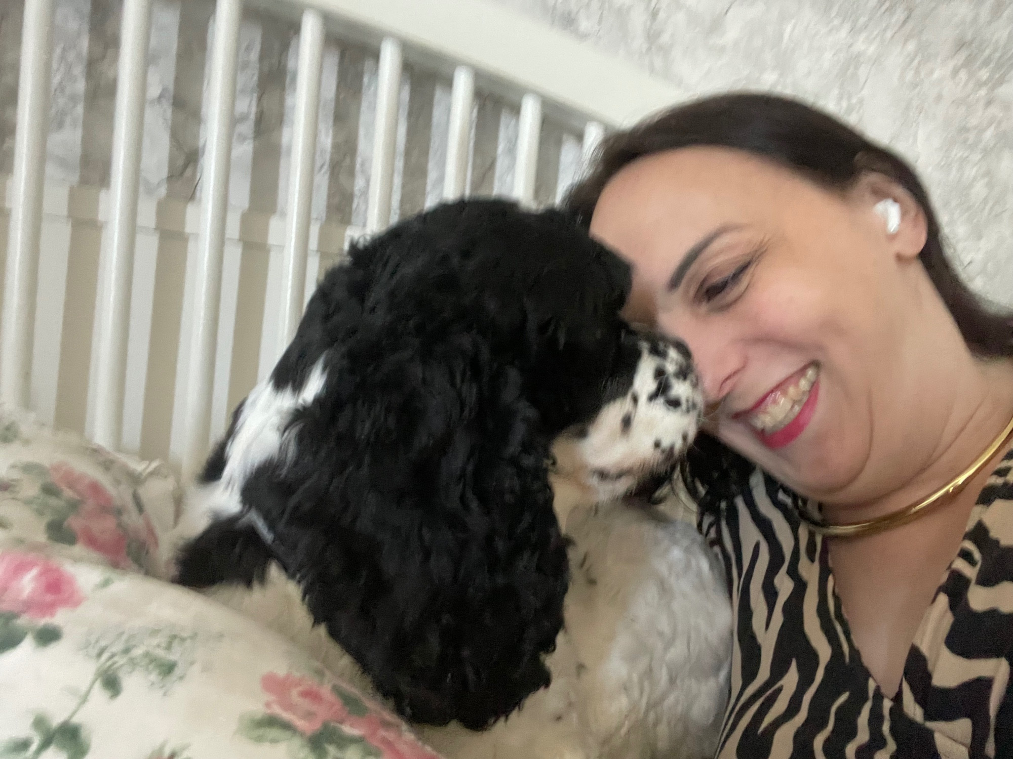 A photograph of a woman smiling with a dog