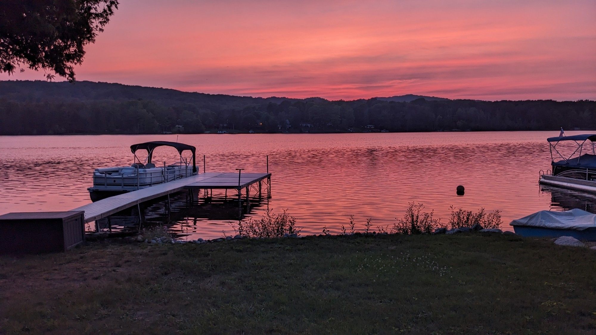 Late sunset on a lake in northern Michigan. Pink hues cover the sky and reflect in the lake.