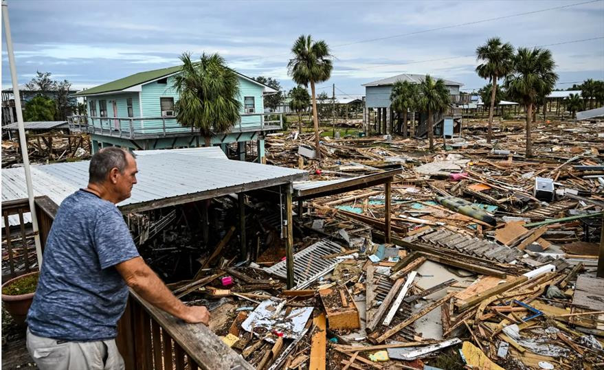 person overlooking the destruction from Hurricane Helene