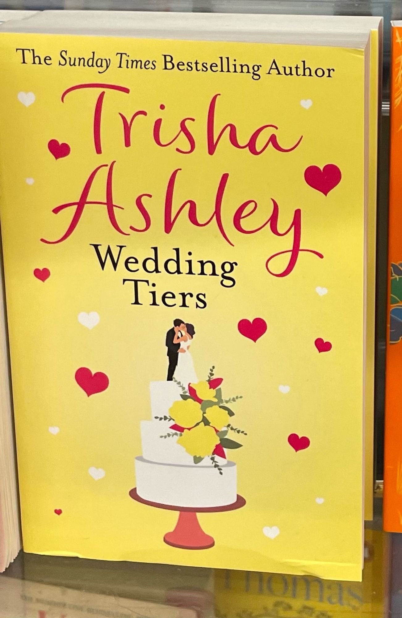 Sunshine yellow cover  paperback edition of Wedding Tiers by Trisha Ashley