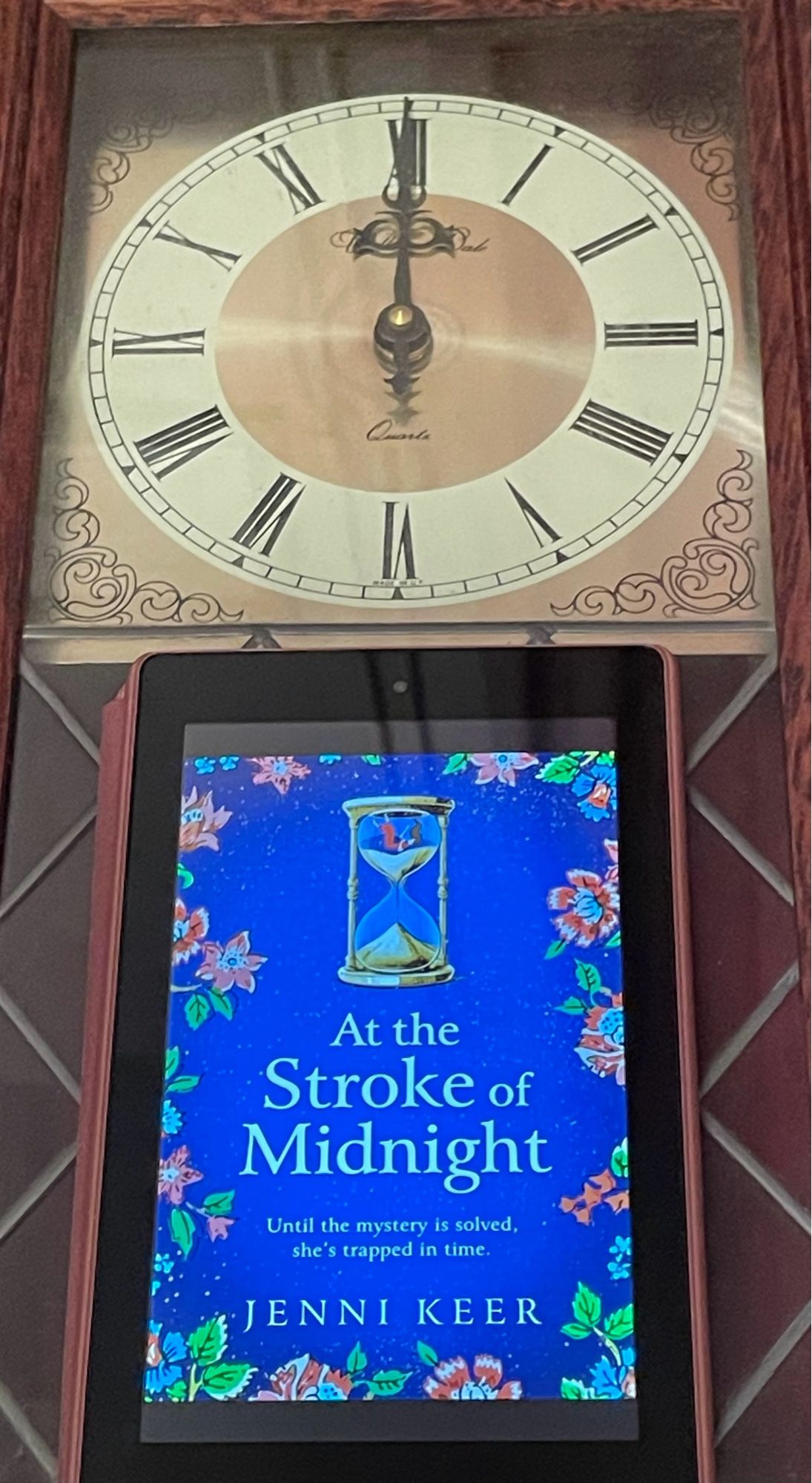 Book cover of At The Stroke Of Midnight by Jenni Keer with a clock face above showing the time of midnight