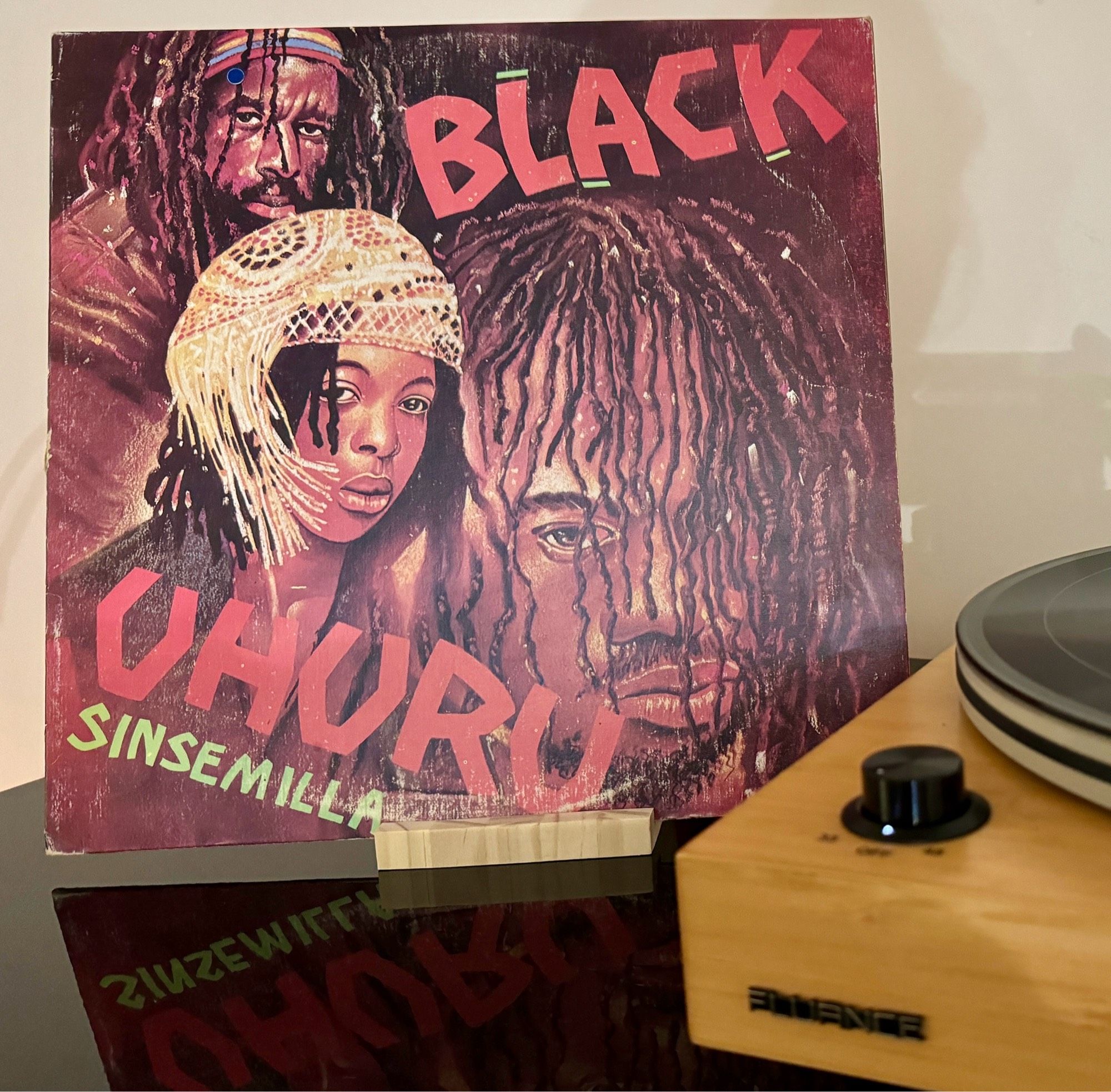 The cover for Black Uhuru’s Sinsemilla album with just the front corner of a turntable in the foreground.