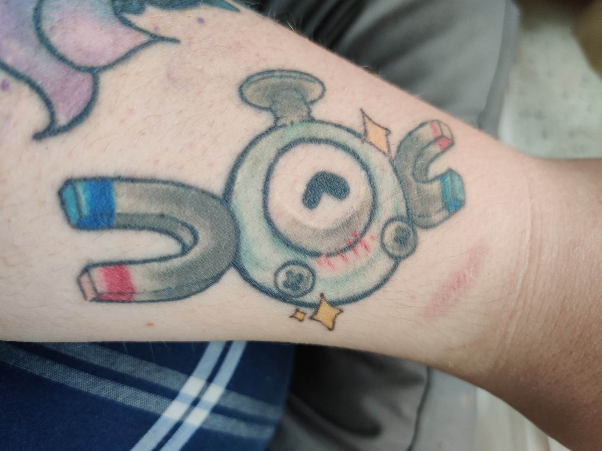 A tattoo located on the left forearm wrist area of the first generation Pokémon, Magnemite. 