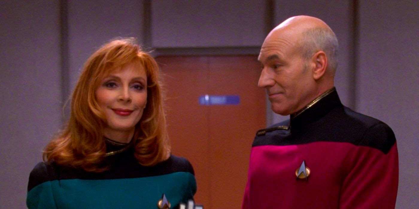 Picard & Crusher in Star Trek: The Next Generation. Their uniforms are red and blue, respectively, with black shoulders.